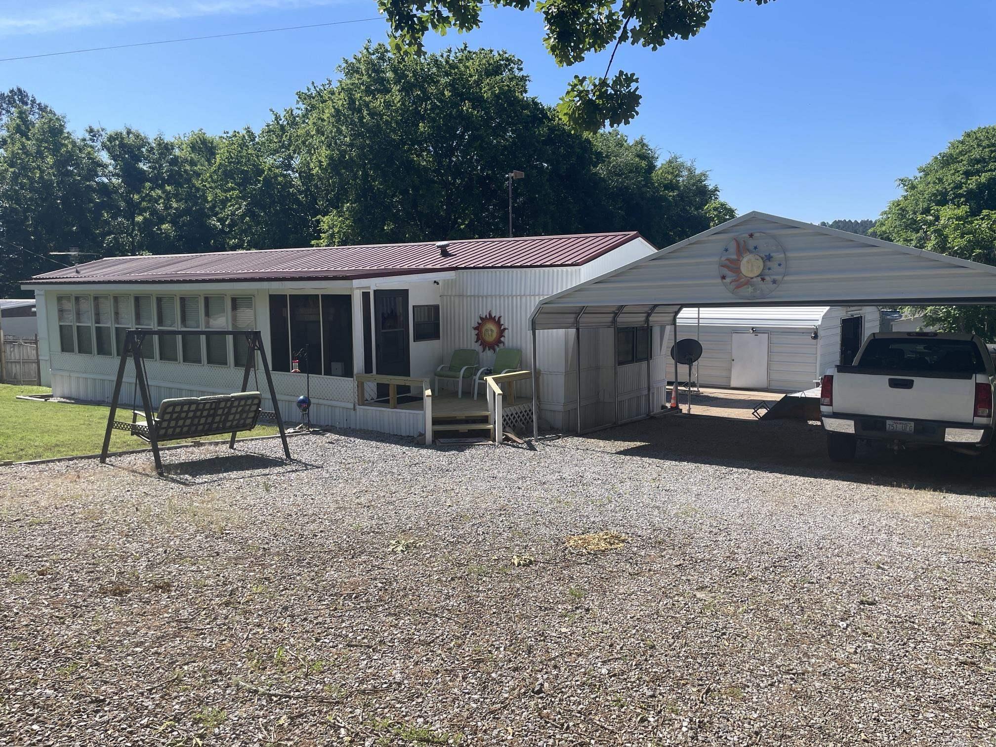 LOCATION, LOCATION, LOCATION! This .36 acre property borders the edge of Northshores Resort on Lake Ouachita. Golf cart ride or walk to boat docks and boat ramp. ** You can't get any closer than this and not be on Corp of Engineer Property.** Home features 3 bedrooms and 2 full baths plus a large kitchen and a light filled sun room. 30x30 heated and cooled shop for projects, storage or a fun hang out. (Currently houses a bar which will convey) Includes a 12x30 metal cover for boat or RV storage, 12x28 storage with doors to park golf cart or other lake toys. Bonus is a large famiily sized (dry) storm shelter! Don't miss out on a great opportunity for lake fun or full time living a stone's throw from Lake Ouachita.***Permanent foundation installed with an acceptable offer*** Agents See showing remarks.