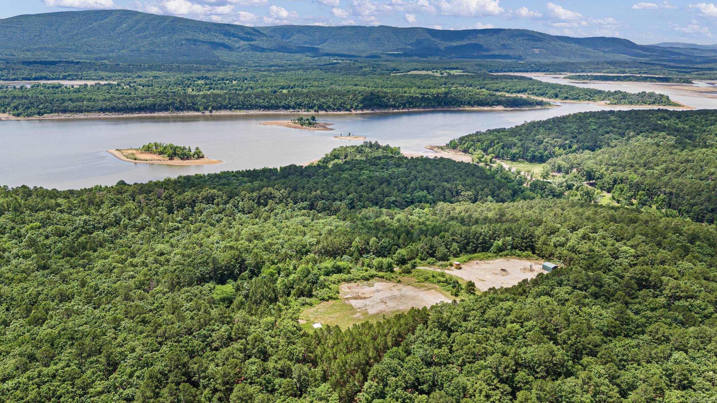 Discover 12 secluded acres near Magazine offering excellent recreational and hunting opportunities. This mostly wooded property features sloping terrain, mature hardwoods, and borders state land that extends to Blue Mountain Lake, providing additional room to explore the outdoors. With its private setting and natural beauty, this property offers an excellent location for a hunting camp, weekend getaway, or future cabin retreat. A gas well is located on the property. Utilities are unknown and no covenants are known to apply. Mineral rights do not convey.