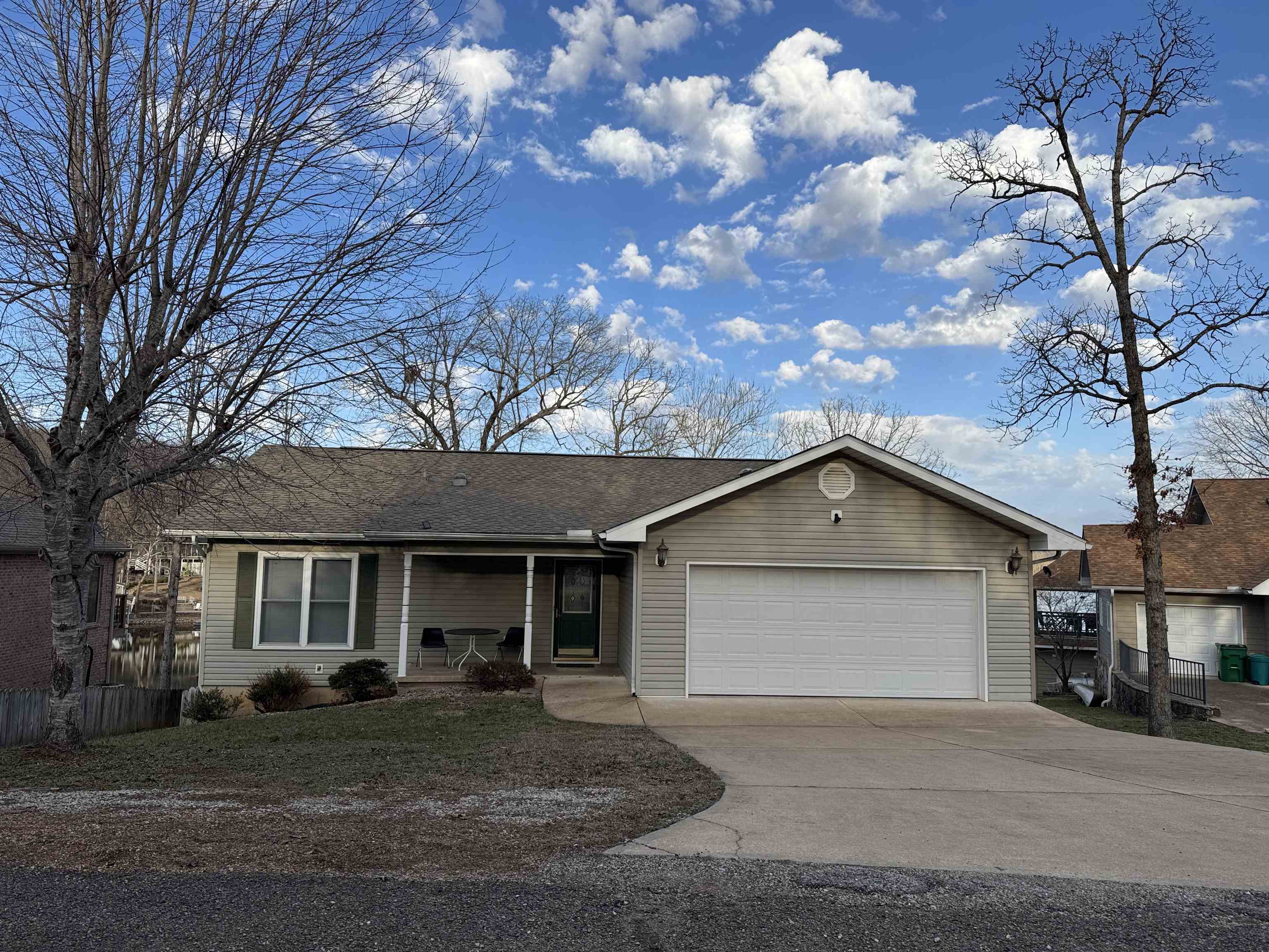 Lake Thunderbird 3 bed/3 bath home with over 3,000 sf of living space.  Features Include: A semi-open floor plan opening onto a sunroom with a fireplace, living room & sunroom both with a panoramic view of  the lake—great for watching 4th of July fireworks. The main floor has 2 bedrooms, 1 with its own bathroom, & a second bathroom. The adjoining 2 car garage has extra room for storage &  is prepped for a generator. The lower level has a large family room big enough for pool table.  Along with the mechanical room are 2 additional rooms: One that can serve as a guest room/office/storage & the other equipped with running water and a LOT of cabinets-formerly used for quilting OR it can be a third bedroom. This room & the family room both open onto a covered patio which has a 2nd wood burning fireplace.  Pride of ownership shows in maintenance & extra features such as separate water heaters for kitchen & bathrooms, a 12v light system in the family room, tubular skylights, easily accessible storage space under the stairs, wires installed & ready for a generator.  Dock. No SID fees. Stacked washer/dryer on lower level stays.  Bill of Assurance under Document tab.