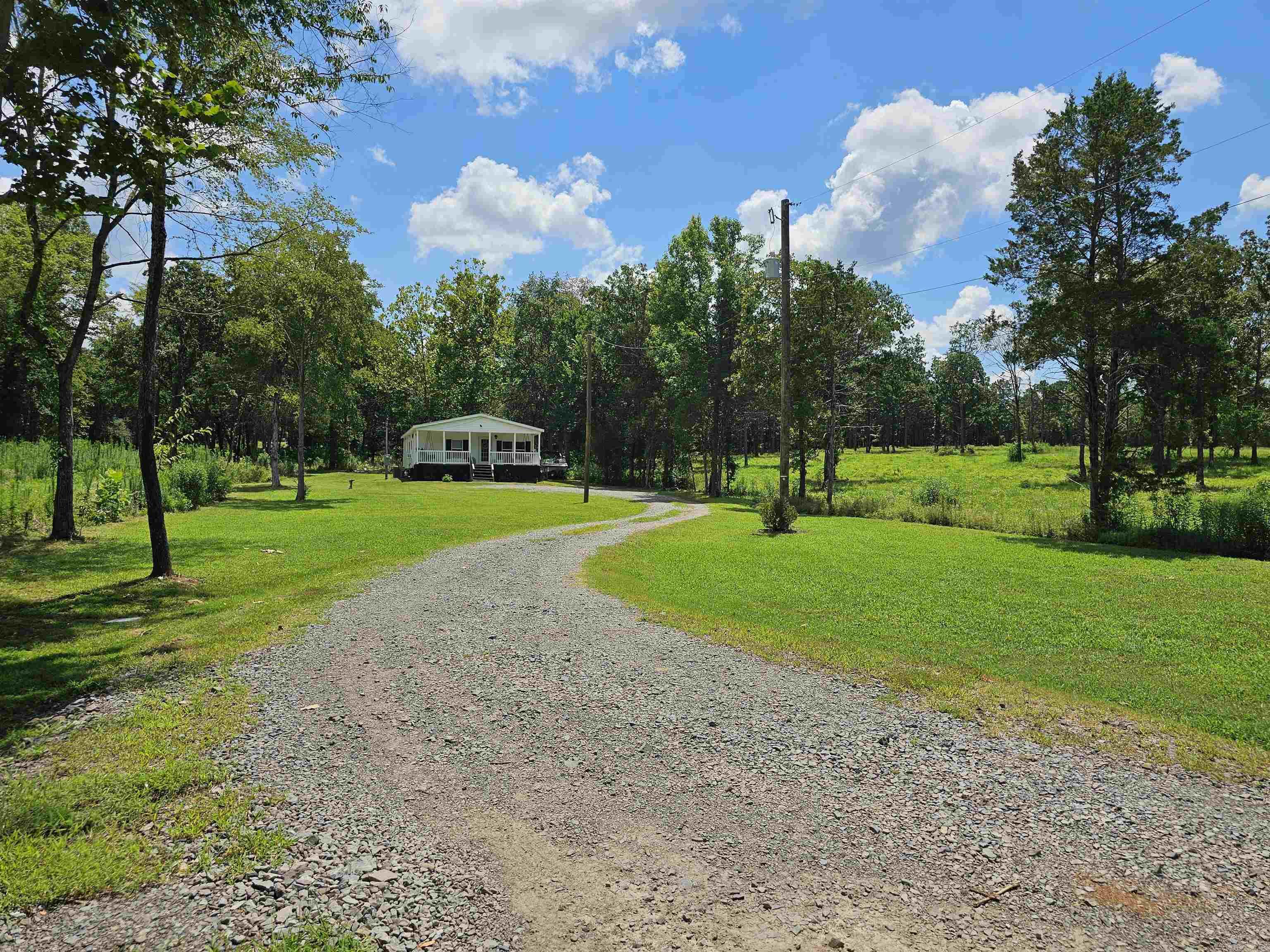 Beautifully maintained modular home on just under an acre. This beautiful home is move in ready and shows off when you walk in the door with its elegant decorating and open floor plan. All bedrooms have large walk-in closets so there is plenty of storage for your things. Enjoy the spa-like bathroom with the large soaker tub, walk-in shower and double sinks. Hang out with your friends at the large kitchen island that is open to the living room. Or just hang out on the large front porch swing and enjoy the peaceful sounds of nature. Enjoy fishing? This property also has a stocked pond! Come see this one quick! Agents read confidential remarks.