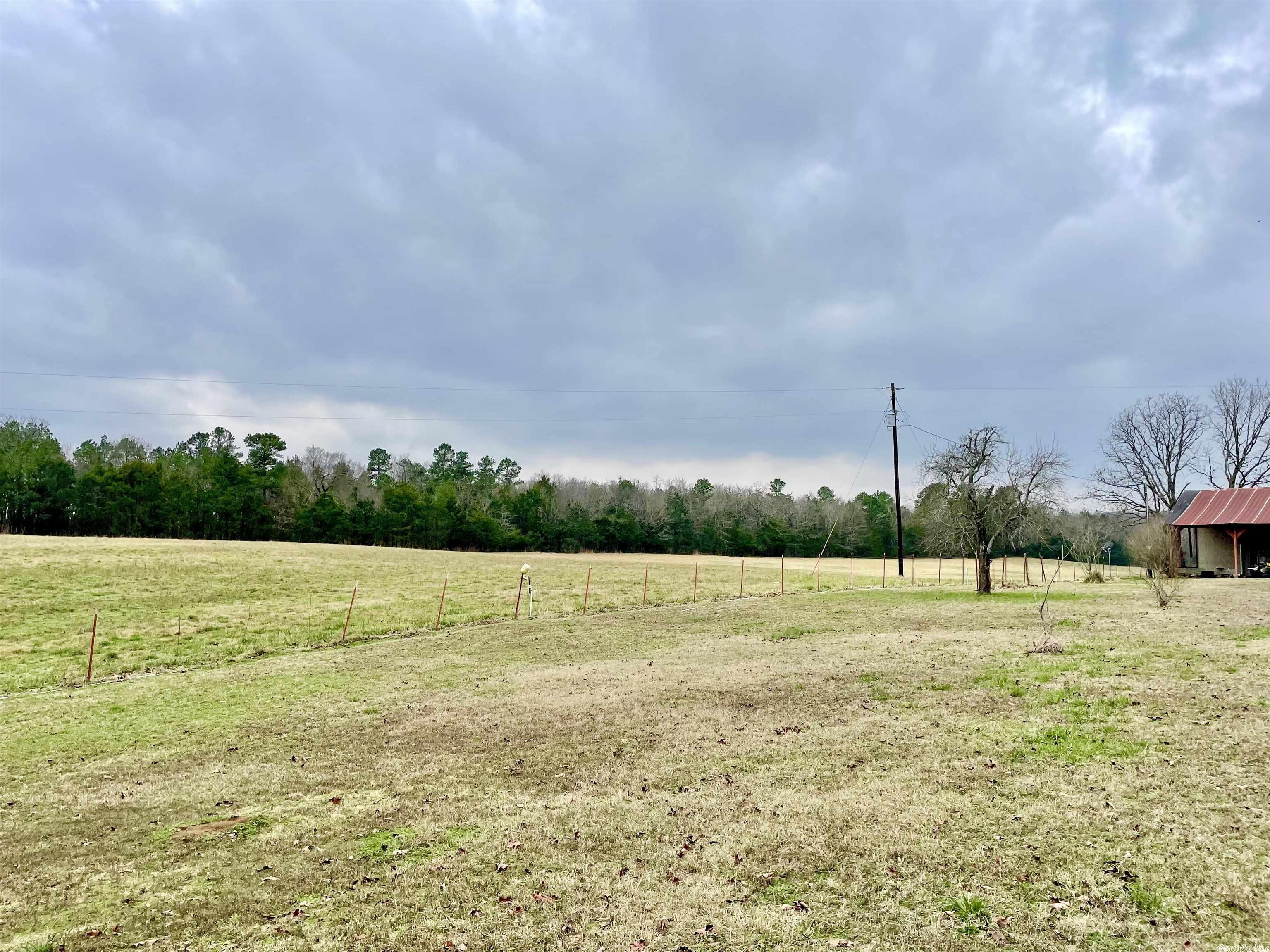 Beautiful 38 acre property w/ mountains all around in the coveted Cherry Hill area! Large spring fed pond. Lots of wildlife! fenced for livestock w/ grazing acres! There is a storm shelter & some out buildings/barn. The rustic cabin needs TLC but could make a great homestead, second home or vacation rental with some repairs! They aren't making any more land, so get yours now! you are only a few mile away form National forest, riding trails, rivers and more in several directions!