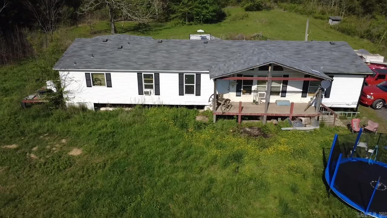 Over 40 acres with a creek, a pond and mountain view. 41.96 acres and a 3 bedroom, 2 bath double-wide mobile home with an extra room that can be a 4th bedroom or den. Pasture land, fenced in pond area and trails through the woods. This is a must see!  Call to arrange a showing!