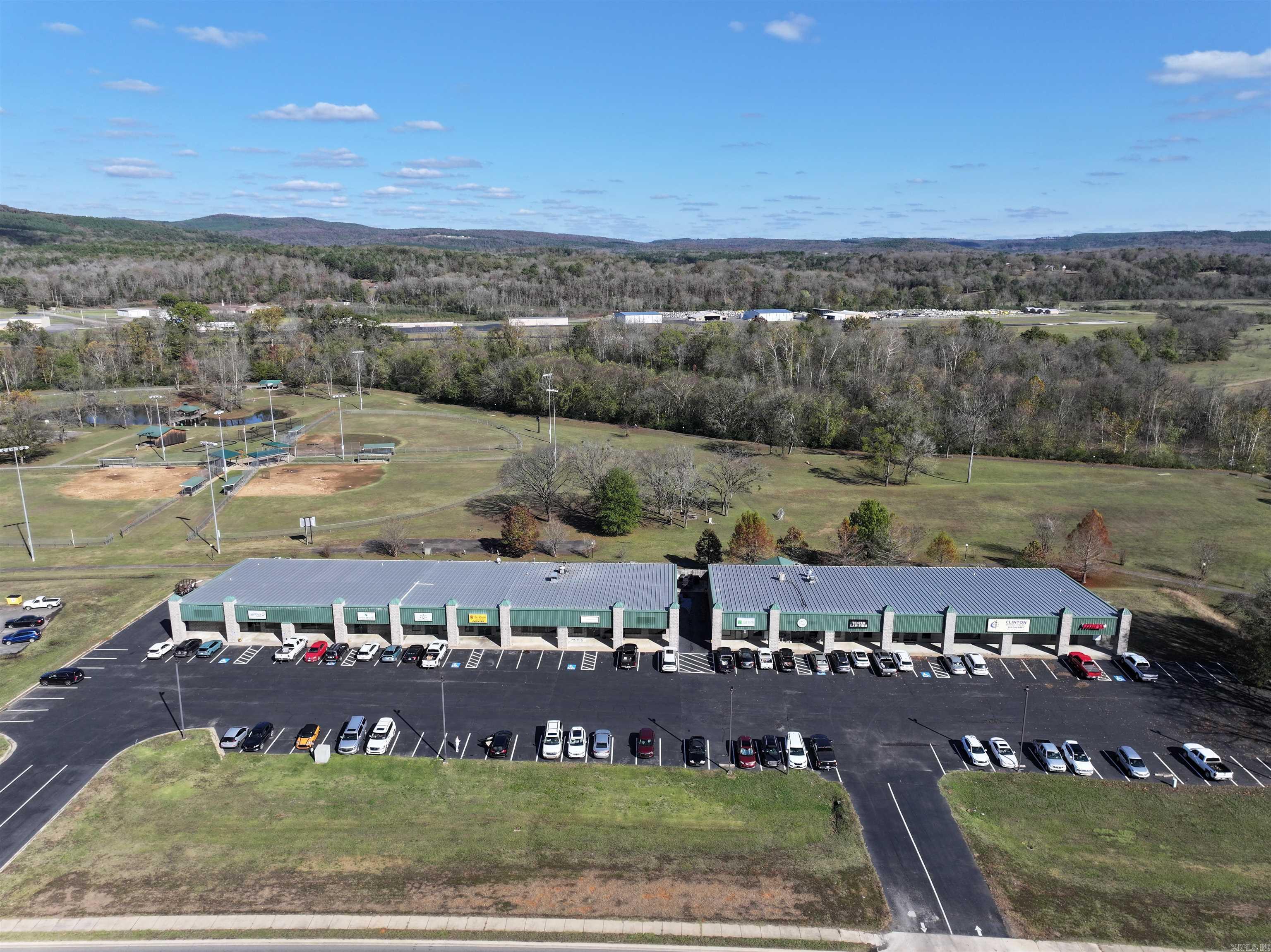 Located at 244 Hwy 65 N in Clinton, Arkansas, this well-maintained retail center offers strong visibility along Highway 65 with traffic counts of approximately 16,000 vehicles per day. The property features a ±13,500 square foot building situated on ±1.30 acres and includes recent capital improvements such as parking lot resurfacing and updated exterior lighting. Zoned C-2 (General Commercial), the center supports a variety of retail, restaurant, and service-oriented uses. Positioned directly in front of Archey Park and near Greers Ferry Lake, the location benefits from steady local traffic, recreational tourism, and a diverse tenant mix that includes restaurant and professional service