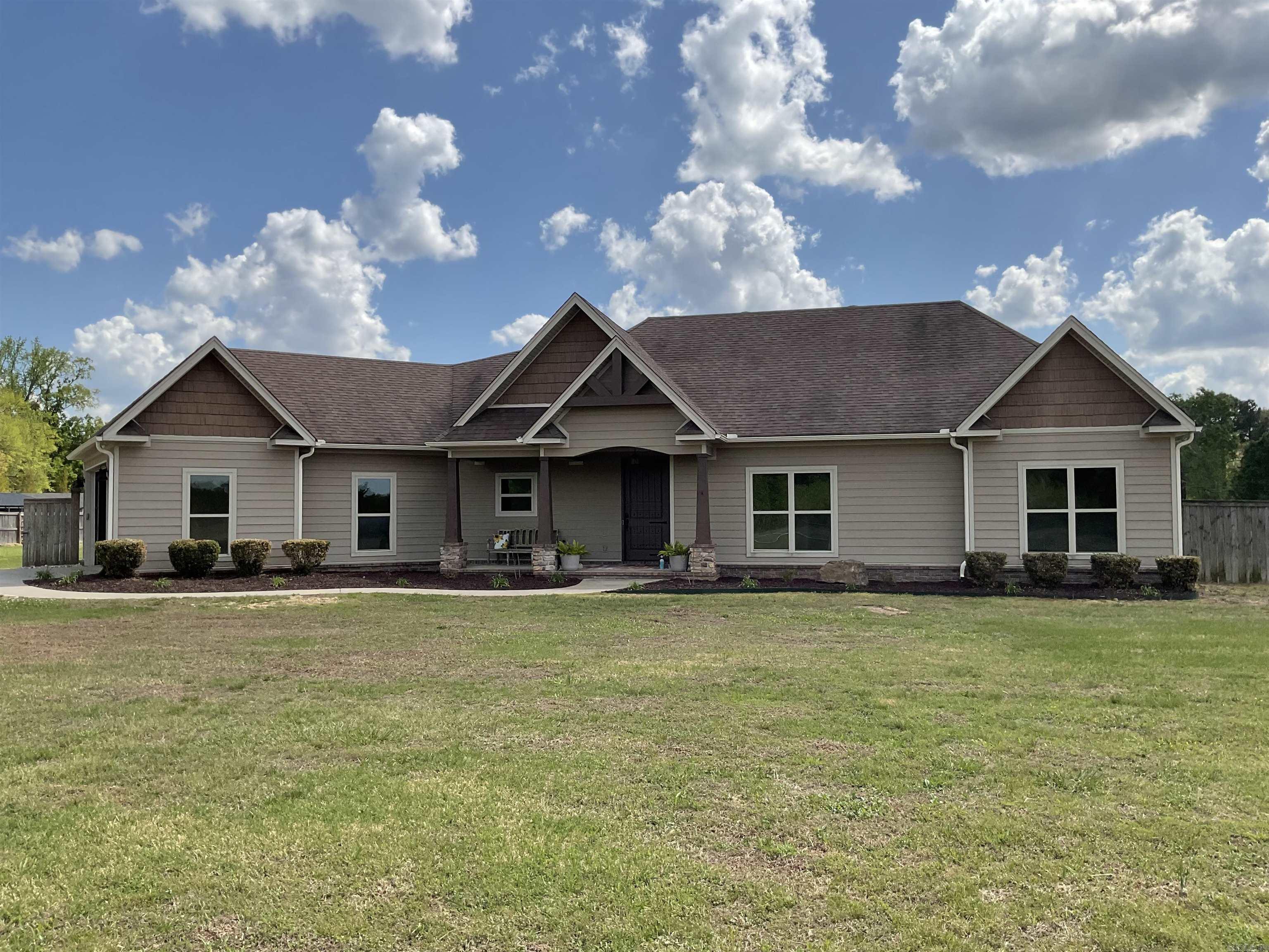 NEED YOUR SPACE AND A BEAUTIFUL BUILT HOME? What a jewel you will discover here.  Sitting on 3.24 acres this immaculate 1959 sq.ft. home should be your choice.  What a wonderful kitchen with more than ample cabinets, pull out drawer pantry, lazy susan, small appliance hideaway, hard surface countertops, breakfast bar, tile backsplash all open to the dining & family room. Other wonderful amenities include gas log fireplace, concrete stained flooring, beautiful built-ins, crown molding thru-out, jack/jill bath between 2 guest rms.  Master suite is tray ceiling & features a remarkable bath equipped with hard surfaced topped vanities, deep soaking tub, walk-in tiled shower with a river stone floor & sitting bench & a huge walk-in closet with built in shelving & 2 built in dressers. Double auto door garage & pull down attic storage leads into the mudroom. Brand new Ruud heat/air system, 50 gal Rheem water heater.
