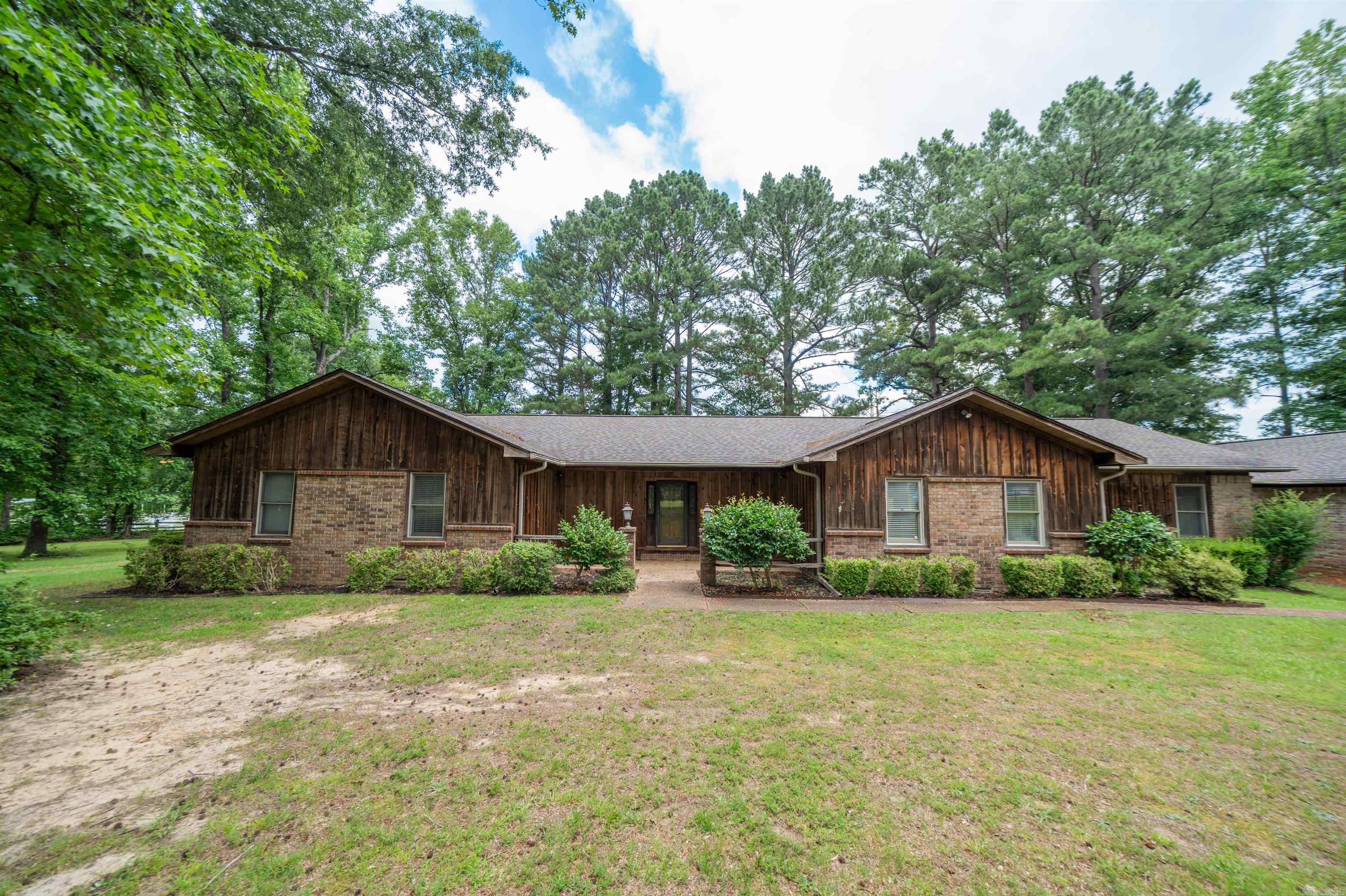 Welcome to your own private retreat where peaceful country living and everyday convenience come together. Situated on approximately 10 scenic acres, this spacious 3-bedroom, 2.5-bath home offers room to spread out both inside and out, with mature trees, open pastureland, a barn, and a thoughtfully designed floor plan just minutes from town. Entering the home you are welcomed by the spacious living area overlooking the beautiful horse pasture with a cozy stone fireplace. Off the kitchen is a den area with amazing views through the sliding glass doors of the beautiful scenic back yard. If a home office is what you want, a home office is what you'll get! This office is an amazing size with built in's all along the back wall offering plenty of storage space. The kitchen offers space for dining at the island but there is also a separate dining area for bigger gatherings. Imagine mornings spent enjoying coffee while overlooking the acreage, afternoons exploring the property, and evenings relaxing beneath the trees while enjoying the quiet of country life. Despite the secluded setting, the property remains conveniently located close to town! Call me today for you private tour!