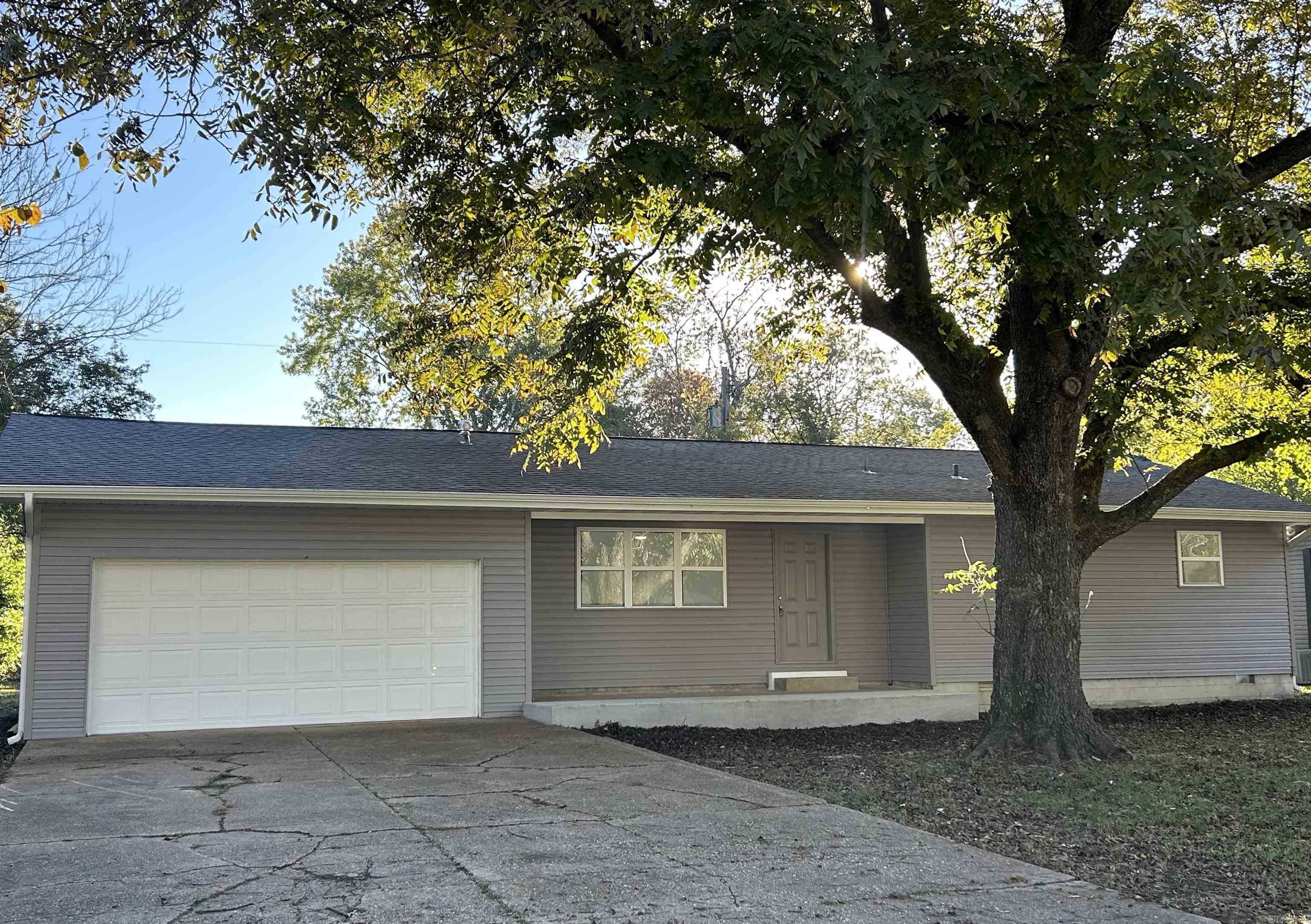This move-in ready 3 bed, 2 bath home features numerous updates including new siding, deck, LVP flooring, bathrooms, kitchen cabinets, stone countertops, stainless steel appliances, windows, doors, and fresh paint. Roof shingles are approximately 3 years old, and HVAC is approximately 2 years old. The primary bedroom offers double closets and an ensuite bath. Additional features include a two-car garage, fenced backyard, and extra closet space with built-in shelving.