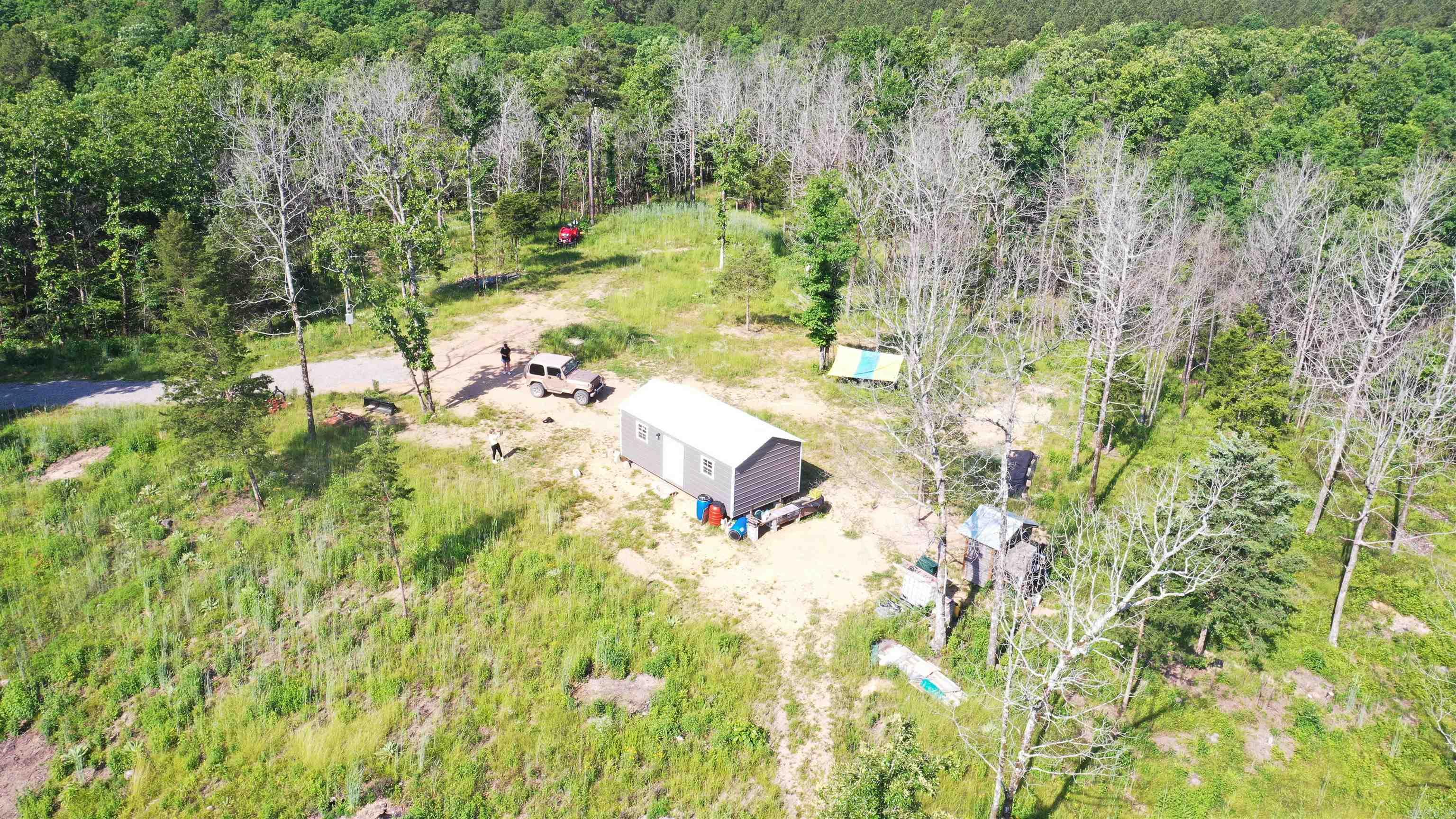 Rare opportunity to own 42.21 acres bordering the Ouachita National Forest — hard-to-find acreage offering privacy, recreation, and breathtaking natural beauty. This wooded property features a gradual hill with an established road leading to the top, where a scenic homesite awaits with a cabin, electric pole already in place, and beautiful long-range views. Two ponds enhance the landscape and attract wildlife, making this an ideal retreat, hunting property, or future homestead. The seller has thoughtfully cleaned and improved the land while preserving its natural setting and character. If you’ve been searching for acreage adjoining national forest land, this is a rare find.