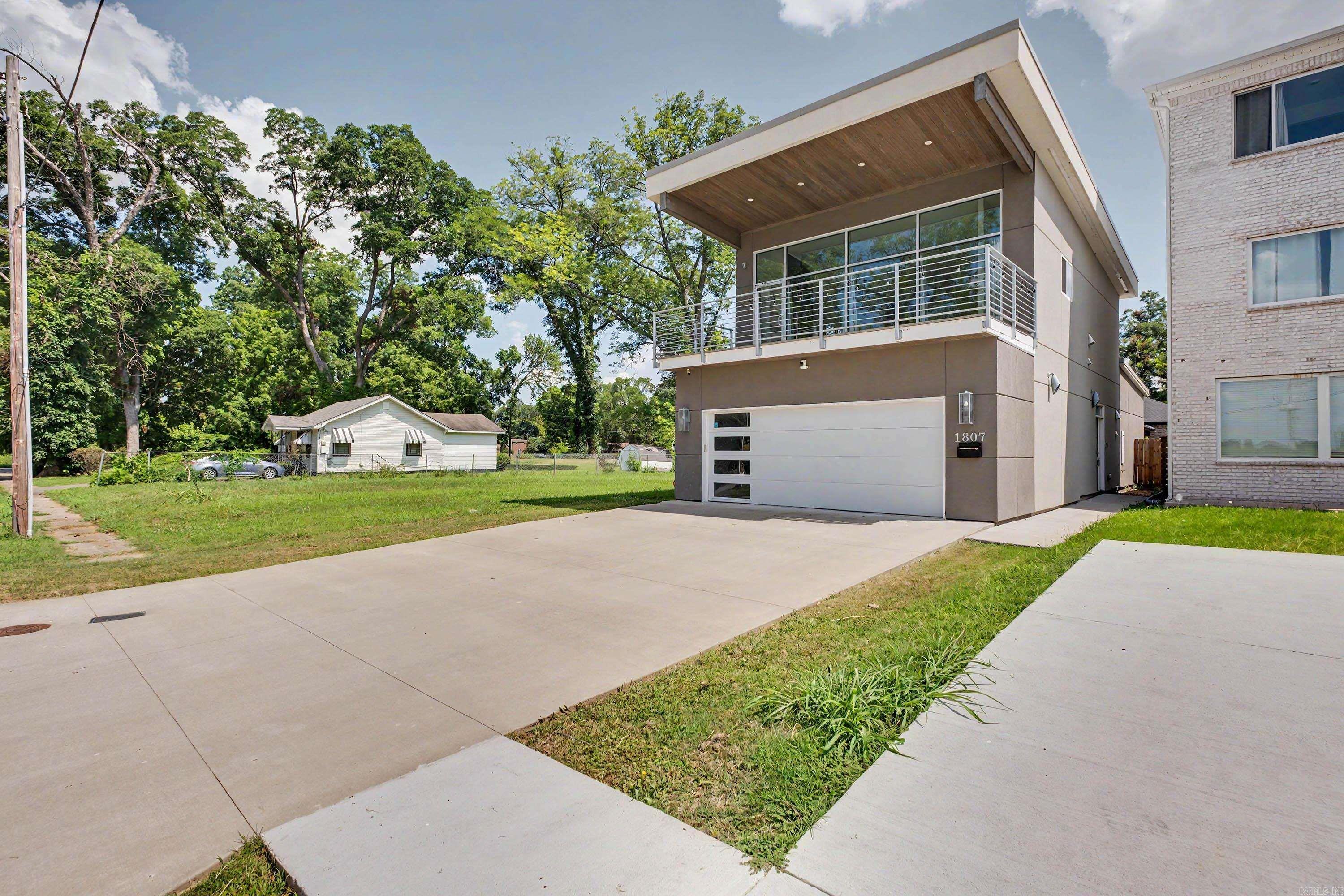 Breathtaking Arkansas River views and an unbeatable downtown location! Just 1/4 mile from the Clinton Presidential Library, this modern 2-bedroom, 2-bath home offers stylish finishes, soaring ceilings, and floor-to-ceiling windows that fill the living space with natural light while showcasing the incredible river views. The open-concept layout features a spacious kitchen with an island, generous storage throughout, and smart home upgrades including security and smart light switches. Step outside to the covered deck and enjoy unobstructed views of the river, or relax in the fully fenced backyard. Additional features include a 2-car garage with a dedicated storage room, laundry room, and plenty of parking. Conveniently located near downtown Little Rock, the Arkansas Museum of Fine Arts, the Arkansas River Trail, restaurants, entertainment, and Clinton National Airport. If you've been searching for a move-in ready home with modern design and an exceptional location, this is one you won't want to miss.