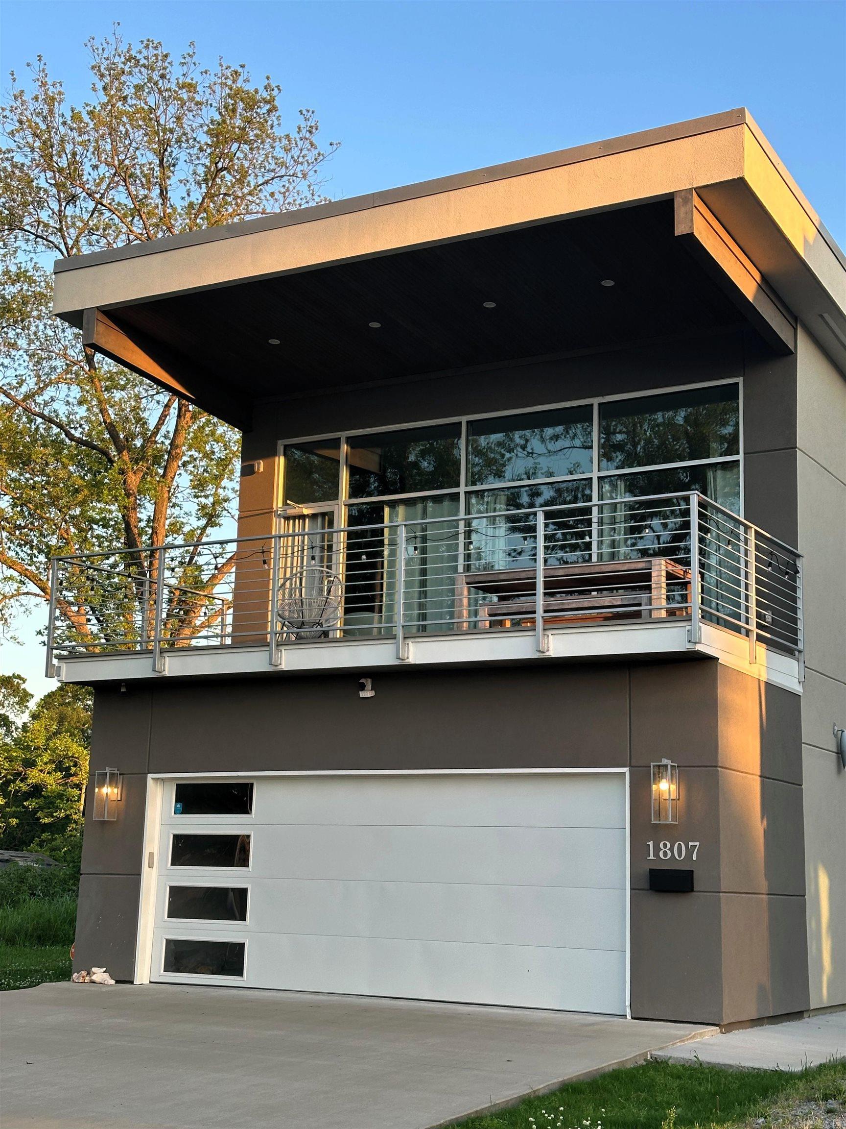 Breathtaking Arkansas River views and an unbeatable downtown location! Just 1/4 mile from the Clinton Presidential Library, this modern 2-bedroom, 2-bath home offers stylish finishes, soaring ceilings, and floor-to-ceiling windows that fill the living space with natural light while showcasing the incredible river views. The open-concept layout features a spacious kitchen with an island, generous storage throughout, and smart home upgrades including security and smart light switches. Step outside to the covered deck and enjoy unobstructed views of the river, or relax in the fully fenced backyard. Additional features include a 2-car garage with a dedicated storage room, laundry room, and plenty of parking. Conveniently located near downtown Little Rock, the Arkansas Museum of Fine Arts, the Arkansas River Trail, restaurants, entertainment, and Clinton National Airport. If you've been searching for a move-in ready home with modern design and an exceptional location, this is one you won't want to miss.