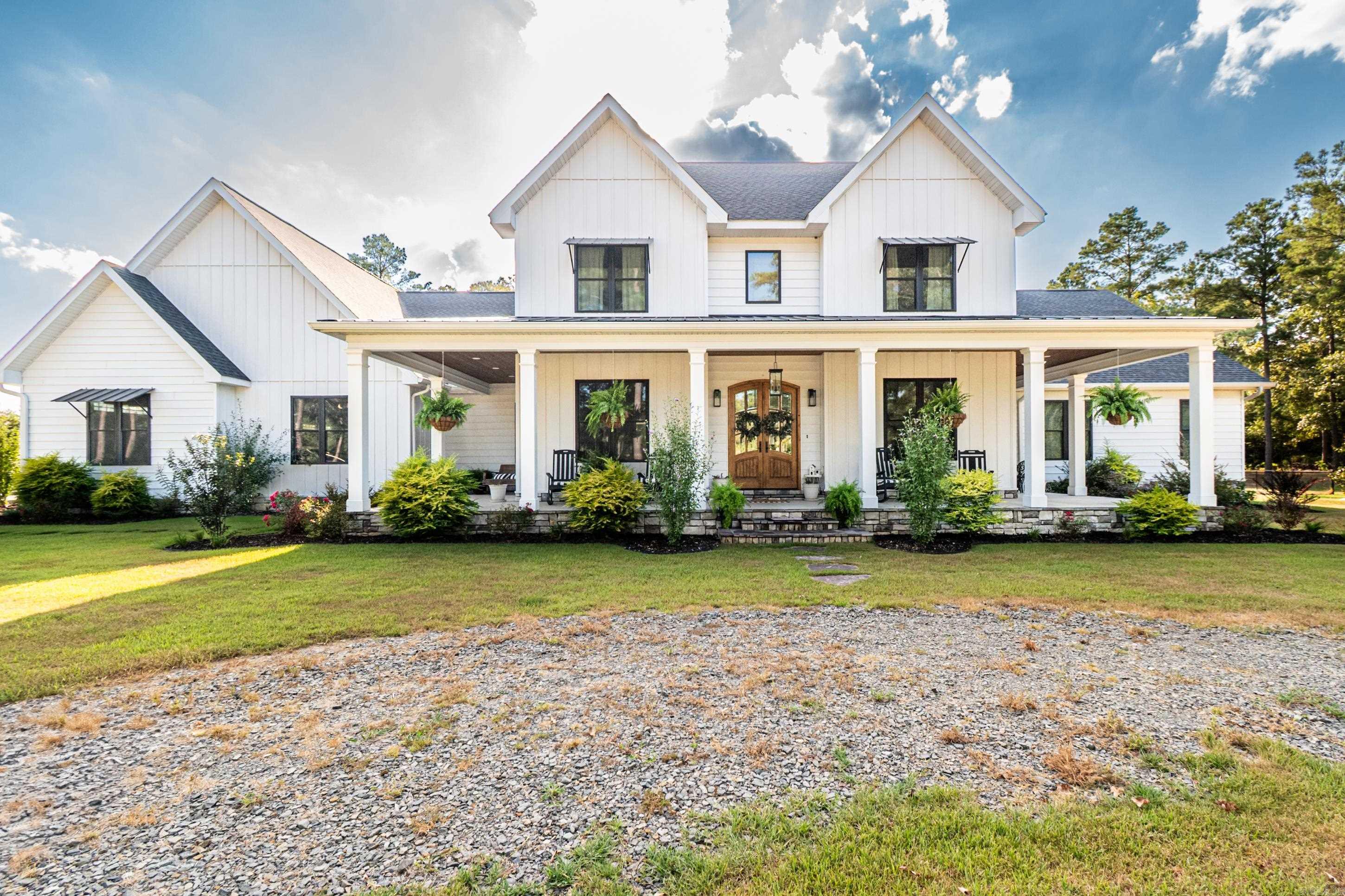 Welcome to this beautiful new build—a one-of-a-kind custom modern farmhouse offering over 4,300 square feet of thoughtfully designed living space. This open-concept home combines timeless charm with modern convenience, featuring quartz countertops, tile floors with the look of hardwood, and premium finishes throughout.  Highlights of the Home:  Two spacious downstairs master suites with oversized walk-in closets  Expansive kitchen with walk-in pantry and quartz countertops  Dedicated office and secure saferoom for peace of mind  Two tankless hot water heaters for endless efficiency  Three-car garage with plenty of storage space  Large floored attic for additional storage  Outdoor Living & Amenities:  Sparkling pool with accompanying pool house  Inviting outdoor kitchen and fireplace—perfect for entertaining  Set on 7.37 private acres, offering both space and serenity  Bonus Feature: A fully finished working beauty shop—ideal for a beautician, dog groomer, or easily transformed into a game room, hobby space, or home business.  This home truly has it all—style, space, and versatility—designed for modern living while embracing the warmth of farmhouse charm.