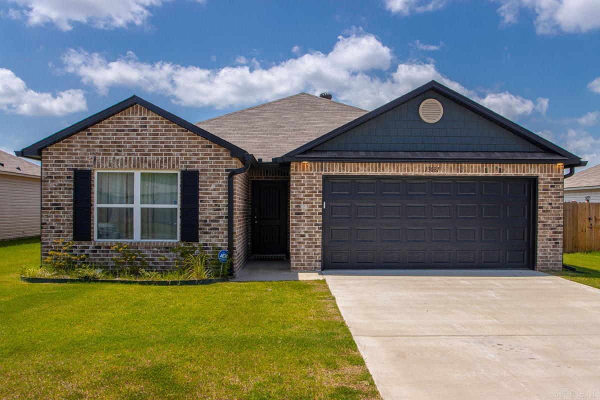 Don’t miss out on this pristine, one-owner home built in 2024, featuring a highly desirable split-bedroom plan with three bedrooms and two full bathrooms. The heart of the home is a completely open-concept kitchen and living area, boasting a functional center island, a spacious dining area, and a stunning wall of windows across the back that floods the space with gorgeous natural light. The private primary suite is a true retreat, tucked away on its own side of the home with a full bath and the luxury of two walk-in closets, while two additional comfortable bedrooms and a full bath sit on the opposite side. Exceptional, high-quality updates elevate this property, including an automatic garage door opener, full exterior gutters, a large laundry room, and a matching refrigerator that conveys with the home. Step outside to a perfectly level, beautifully maintained backyard enclosed by a premium wooden privacy fence with side-gate access. The outdoor space is primed for entertaining, featuring a custom, creative rock patio path leading to a central gathering area perfect for cookouts, plus a bonus outdoor storage building that remains with the property. See Remarks