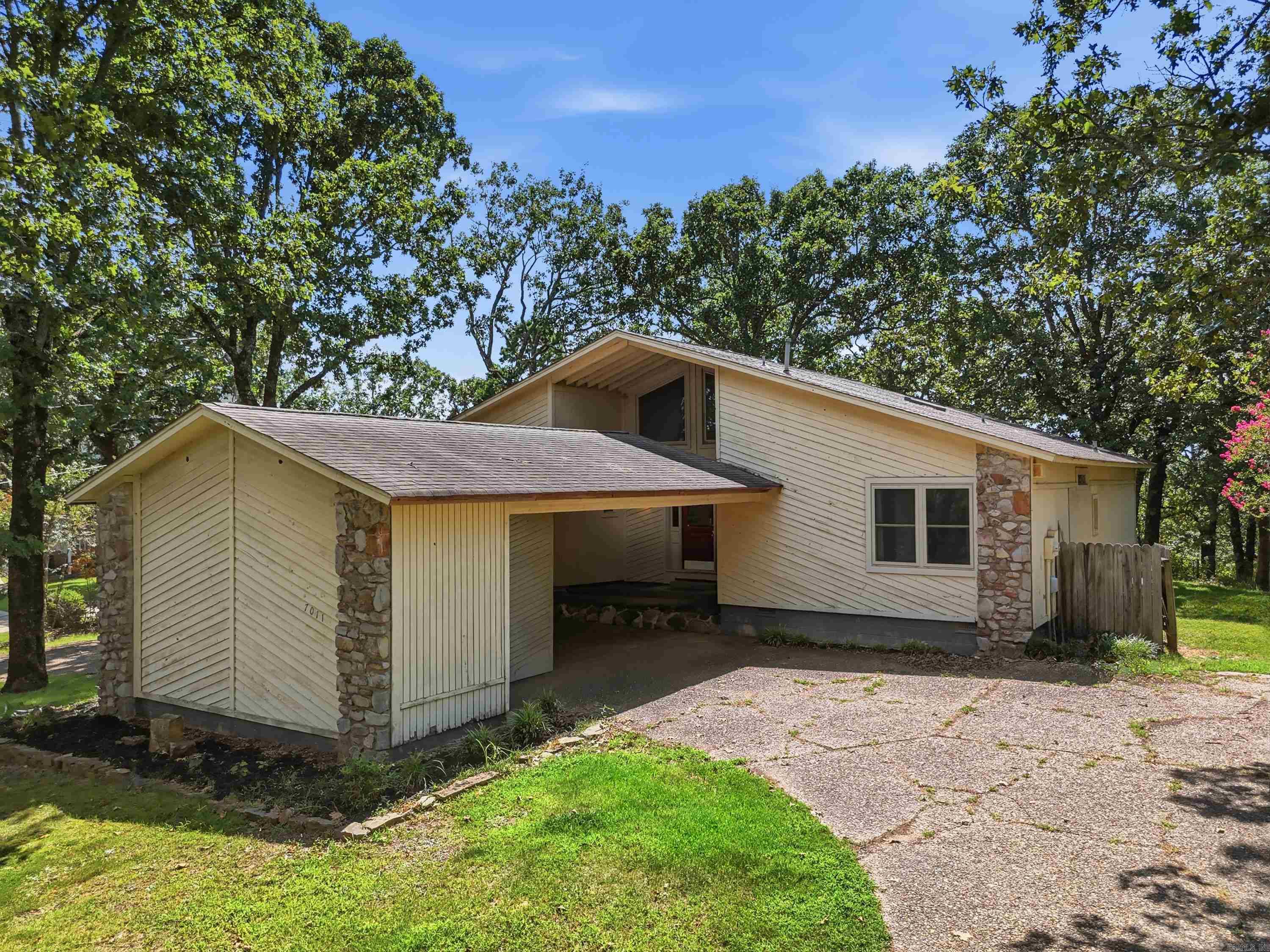 Welcome to this hidden gem nestled on a spacious half-acre lot in the desirable Westwind subdivision of North Little Rock. Offering 2,024 square feet of living space, this 2-bedroom, 2-bath home combines comfort, convenience, and endless potential. Inside, you'll find a spacious floor plan with soaring vaulted ceilings, abundant natural light, and plenty of room for entertaining family and friends. The generous living areas provide flexibility for everyday living while offering a welcoming atmosphere throughout. Step outside and enjoy the peaceful surroundings of this quiet neighborhood, where deer are frequent visitors to the backyard, creating a tranquil retreat just minutes from the city. The large lot features a fenced dog run, ample outdoor space, and a convenient circle drive for easy access and additional parking.Major updates include replacement windows installed in 2018-2020 and an HVAC system replaced in 2018, providing peace of mind for years to come. Ideally located within 10-15 minutes of the Arkansas State Capitol, Big Dam Bridge, Pinnacle Mountain, shopping, dining, and entertainment, this home offers the perfect balance of accessibility and privacy.