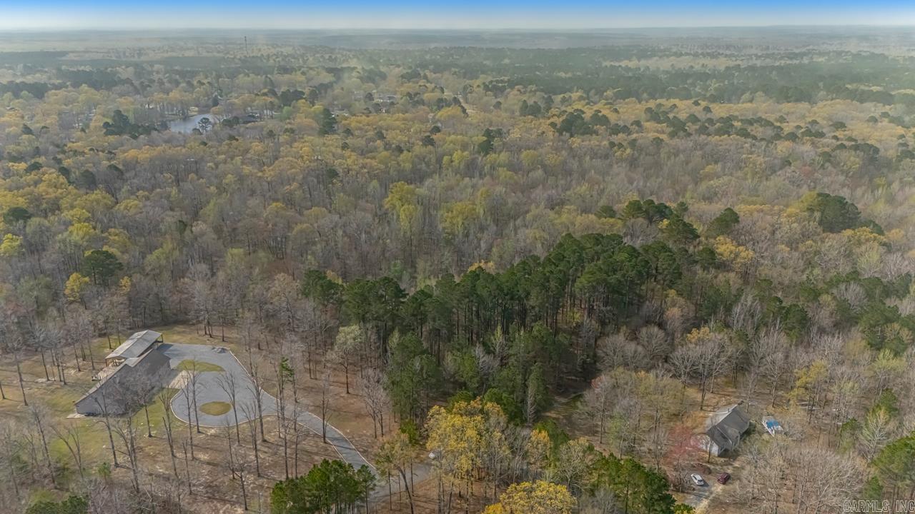 An exceptional opportunity to own 12.89+- acres of beautiful, wooded land in a desirable subdivision in Saline County. These two vacant residential lots are being sold together and offer a peaceful, natural setting with a creek running through the back of the property. Please park on Lakeshore drive if viewing property. Do not attempt to drive on lots or on neighboring houses' driveways.