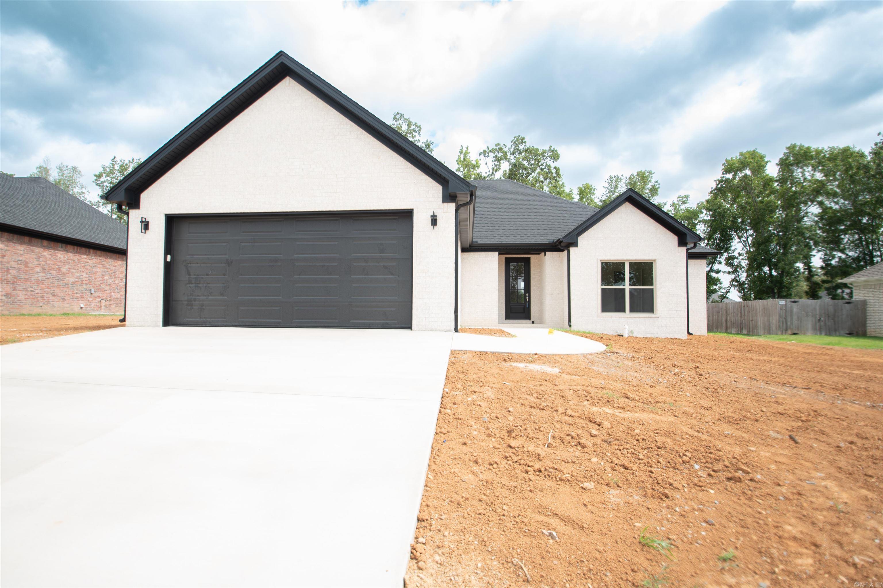 New construction in Beebe with clean modern finishes, warm wood tones, and a functional layout that works for everyday living. This home offers 3 bedrooms, 2 bathrooms, plus a dedicated office/flex room that could also make a great nursery, playroom, or guest space. The open living, kitchen, and dining area has tall ceilings, natural light, luxury vinyl plank flooring, and a neutral color palette that feels fresh without being cold. The kitchen features painted cabinetry, a wood-style island, quartz-style countertops, stainless-steel appliances, pendant lighting, and plenty of storage. The primary suite includes a spacious walk-in shower with floor-to-ceiling tile, a double vanity, and a huge walk-in closet with modern finishes. Outside, you’ll find painted brick, black exterior accents, a covered back patio with wood ceiling detail, and a backyard view. Located in Beebe with easy access to schools, shopping, and I-57, this home is move-in ready and built with style, comfort, and low-maintenance living in mind.
