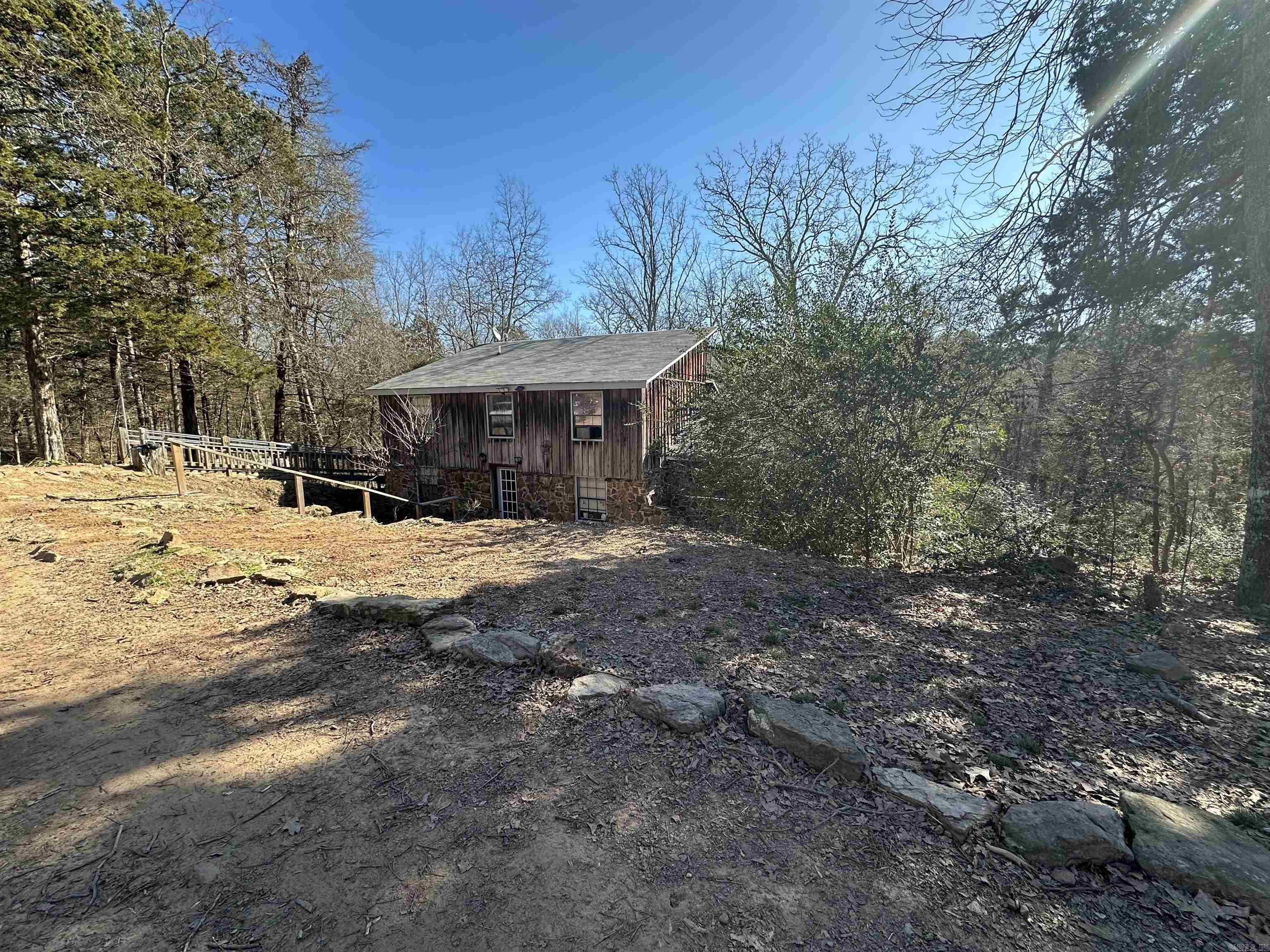 Have you been looking for a home to homestead and the ability to work remotely? From wet weather creek, fruit trees, berry bushes, and many more possibilities.  Large back deck to entertain, grill or just kickback and relax. Primary bedroom on main level, 2 bedroom and a bonus room/office upstairs with full bathroom. 24x30 shop and 10x16 outbuilding/chicken coop. Large laundry room/pantry. Man cave under the house also used as safe room with natural rock that gives a little extra charm. All this sitting on 5 Acres M/L. Brand new HVAC unit. Call today for your viewing appointment. Let's make it yours. Agents see remarks.