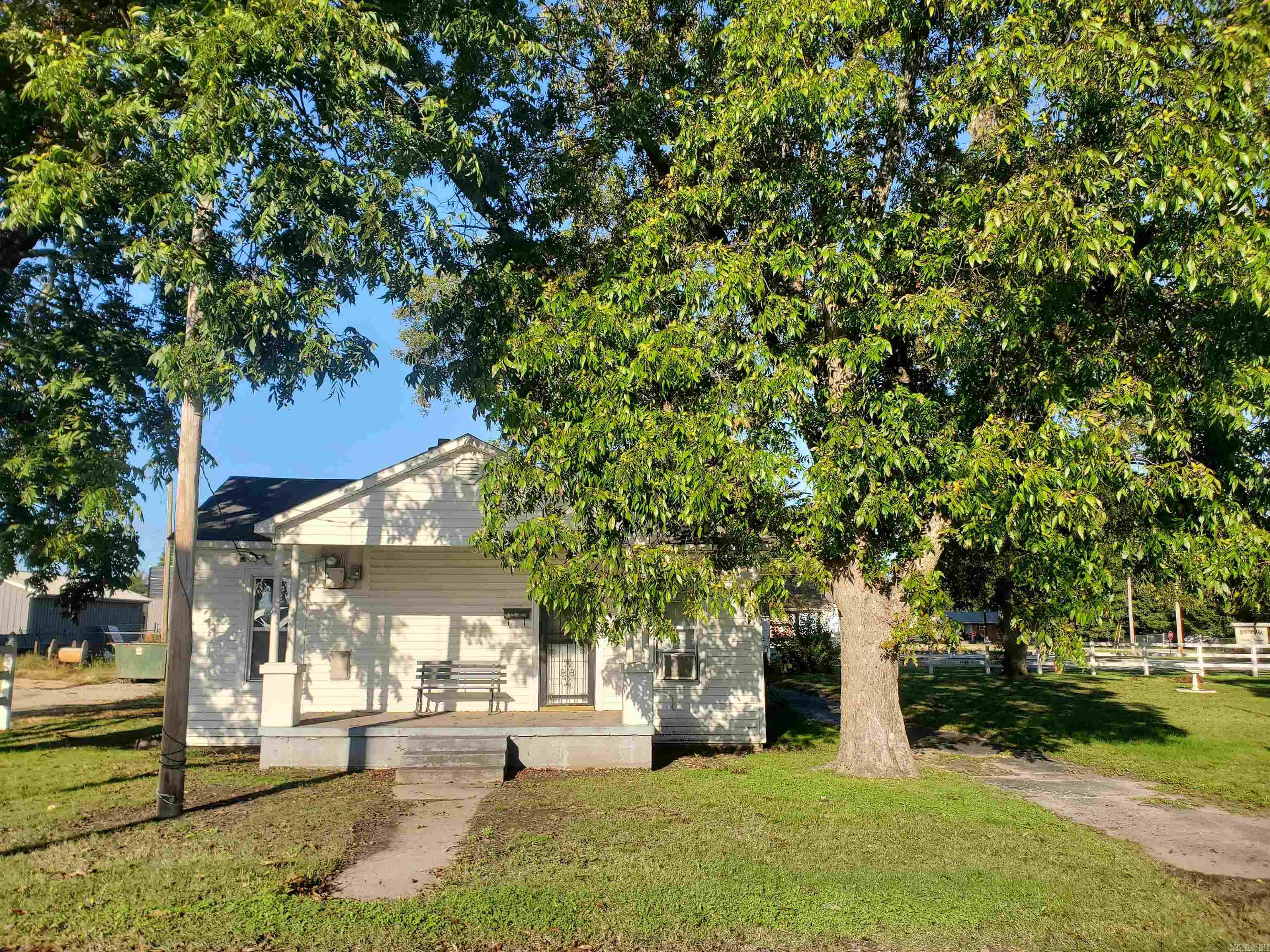152 N Moore is a charming 784 Sqft, 2BR, 1BA home sitting on a 170'x100', 0.39 Acre lot. This cozy home offers original hardwood floors, new windows, a one car carport and a very nice 24'x32' slab patio. The lot is fenced in with a beautiful white vinyl fence with 6 mature pecan trees. This property is a must see!