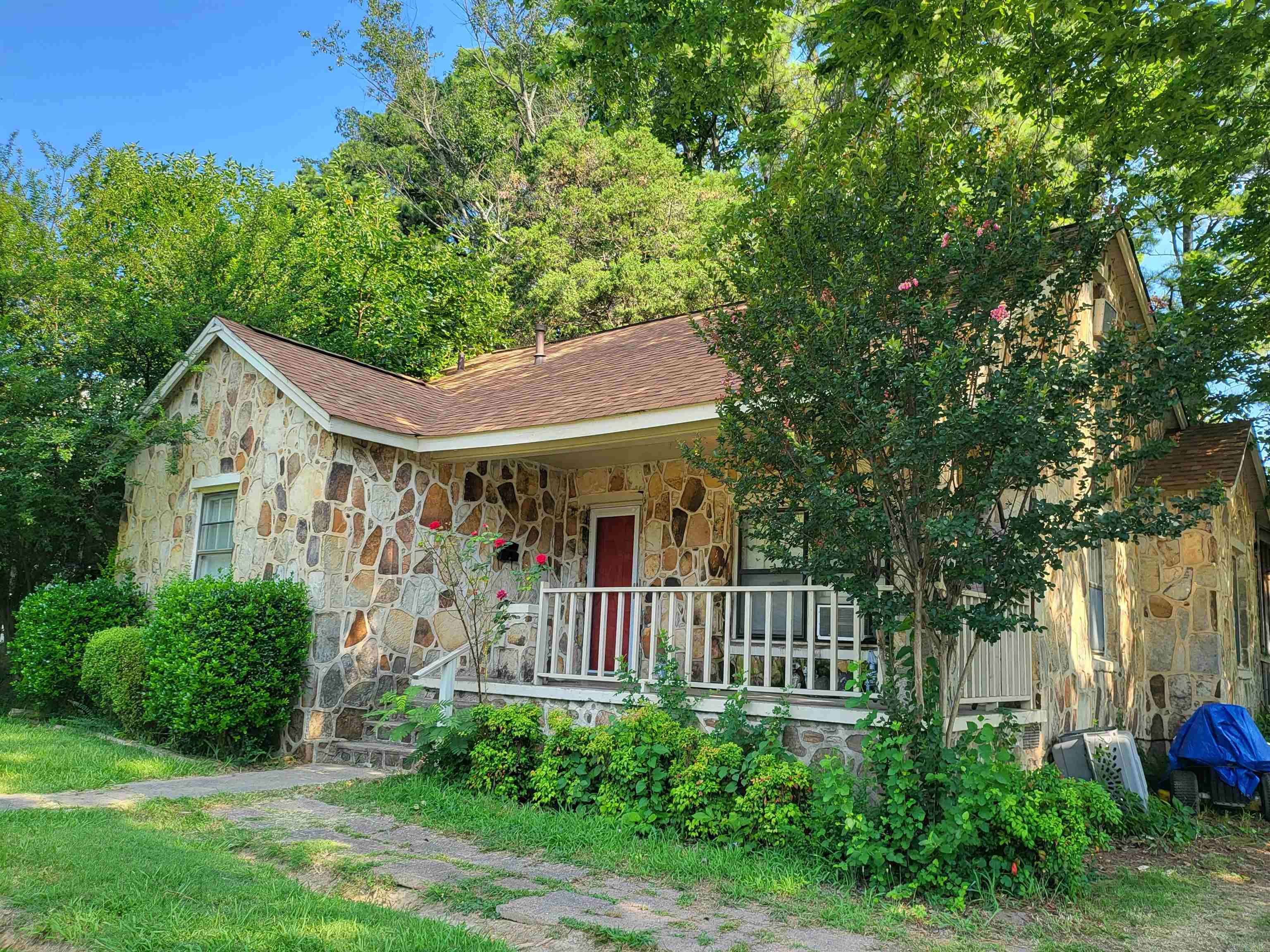 Prime central Jonesboro location! This well-maintained 4-bedroom, 3-bath home offers convenience, space, and a versatile floor plan just minutes from shopping, dining, medical facilities, and everyday amenities. Located on a corner lot, the property features a covered front porch, spacious fenced backyard, back deck, storage building, and a separate workshop with electricity. The inviting interior includes beautiful hardwood flooring throughout the living room and three bedrooms, along with easy-care tile flooring in the kitchen, laundry room, office, and primary bathroom. The upstairs fourth bedroom features new carpet and provides excellent flexibility as a second living area, home office, hobby space, or guest area. A private addition at the rear of the home includes the primary bedroom, bathroom, office, and laundry room, creating a functional retreat with direct access to the outdoor living space. With generous storage, multiple living areas, and a desirable location in the heart of Jonesboro, this home offers a rare combination of convenience and flexibility.