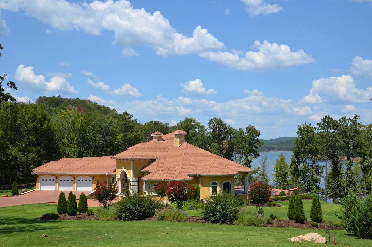 Luxurious Mediterranean home w/private, multi-slip dock, gorgeous lake view on 3.8 acres.  Built by a master craftsman, this elegant custom home features hand chosen granite counter tops, travertine floors, Brazilian Tigerwood flooring, salt water pool, outdoor kitchen, geothermal HVAC system, theater room, custom wrought iron railing, sprinkler system,security system, 2 fireplaces, 10–16’ ceilings, Interlock tile roofing, Pella windows & doors. Less than 15 min. from 2 golf courses. Would sell furnished.