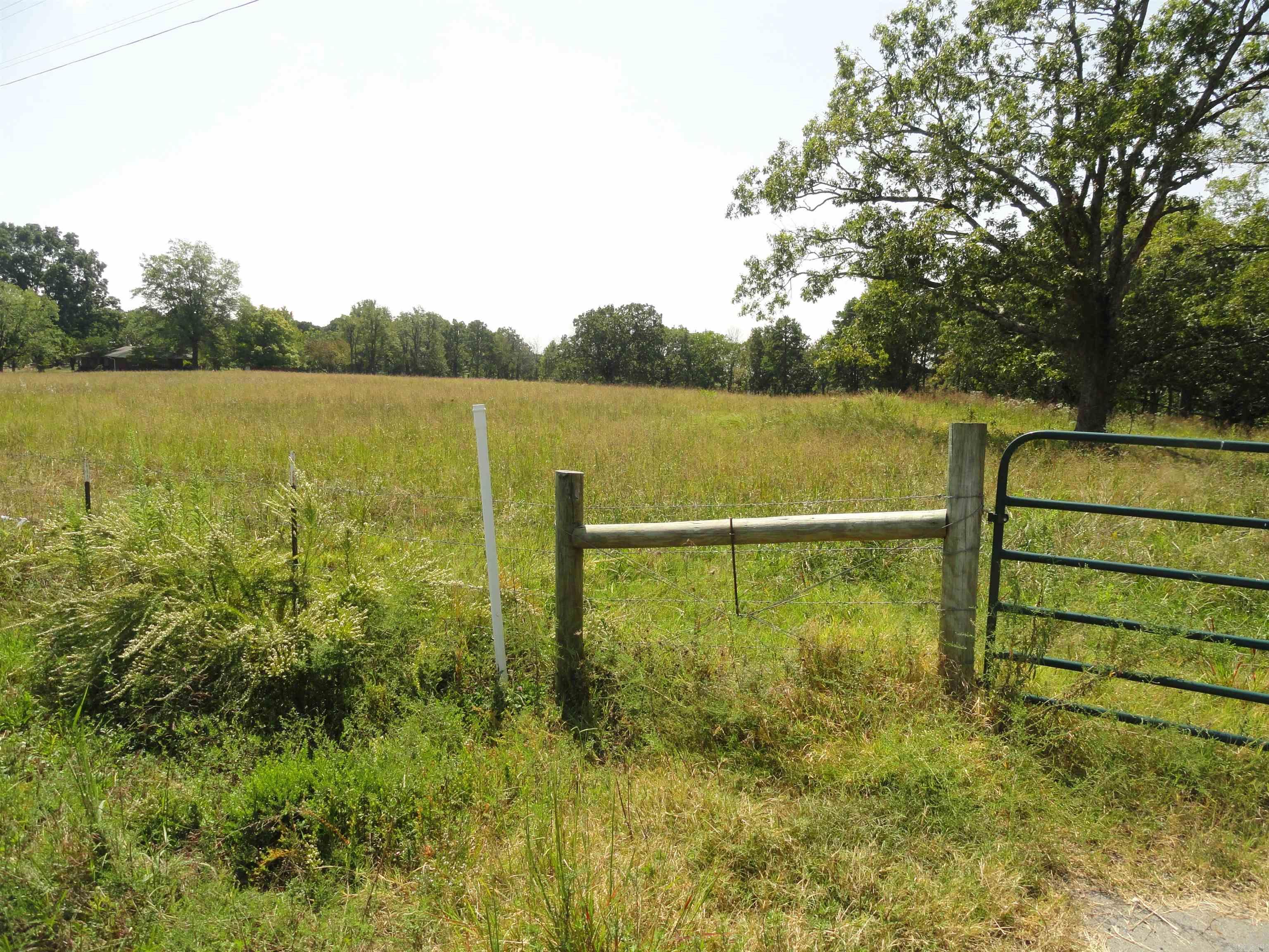 Beautiful 10-acre tract with with approx. 5 acres of open pasture and 5 acres of woods, offering a perfect mix of open space and privacy. 900’ of Hwy 65 frontage provides easy access, and the level terrain near the road makes a great homesite or business location. Property includes an existing cement slab ready for a small home or storage building, plus an old open-air barn/shed. Water and electric available at the highway. Land gently slopes downhill into the wooded area, ideal for exploring or creating a private retreat. Just minutes to Greers Ferry Lake—enjoy fishing, boating, and camping nearby! Only 5 miles to Clinton, AR, where you’ll find a Walmart Supercenter, hospital, small airport, building supply stores, and restaurants. Clinton offers small-town charm with modern amenities and is home to the famous National Chuck Wagon Races. Conway, AR is only 48 minutes away and Little Rock is 90 minutes away. Great opportunity to build your dream home, hobby farm, or weekend getaway in the heart of the Ozarks!