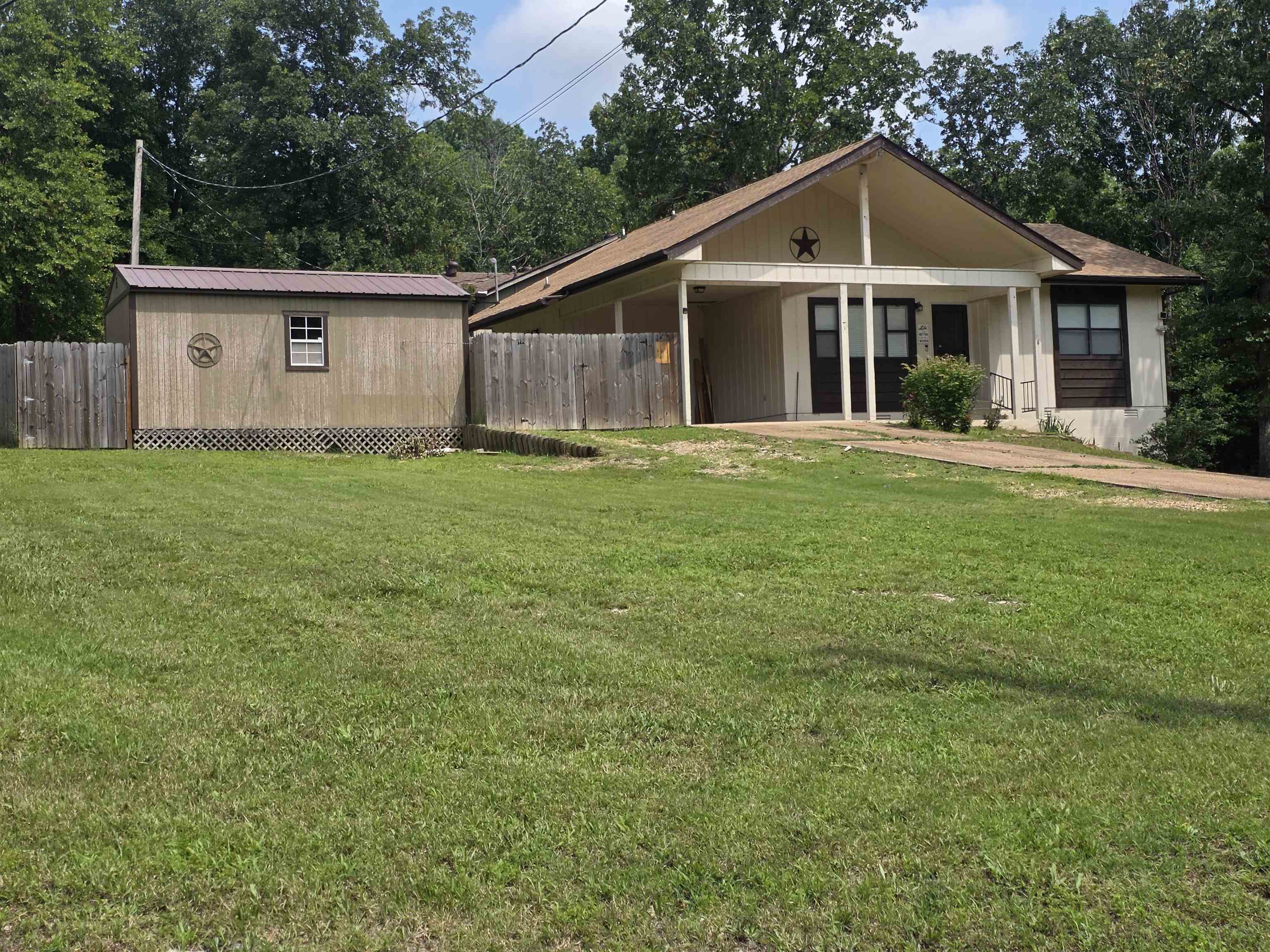 This is a Super-cute home with 2-bedrooms and 1 and a half bathrooms. It is sitting on 2 corner lots for over half an acre of property. This home has newer laminate flooring, new architectural shingle roof, a 12' x 20' storage shed/shop with a roll up door inside the fenced-in part of the yard. The yard is partially fenced with a wooden fence for privacy when you are spending time on your back deck. There is also a nice covered front porch The extra lot allows for expansion or growth or just acts as a buffer for privacy as well. This home has a great location; cart distance from the South Golf course, less than half a mile as the crow flies, about half a mile to the Southfork River as well, and it sits just up the street from Cedar Valley Park which is only about 600ft away. Don't forget that ownership of this home comes with access to all of the Cherokee Village amenities. Like the two 18-Hole golf courses, 7 lakes for fishing, swimming and boating. The Thunderbird center for swimming in the pool or a game of mini golf. And dont forget about the beautiful Southfork river for floating, kayaking and fishing.