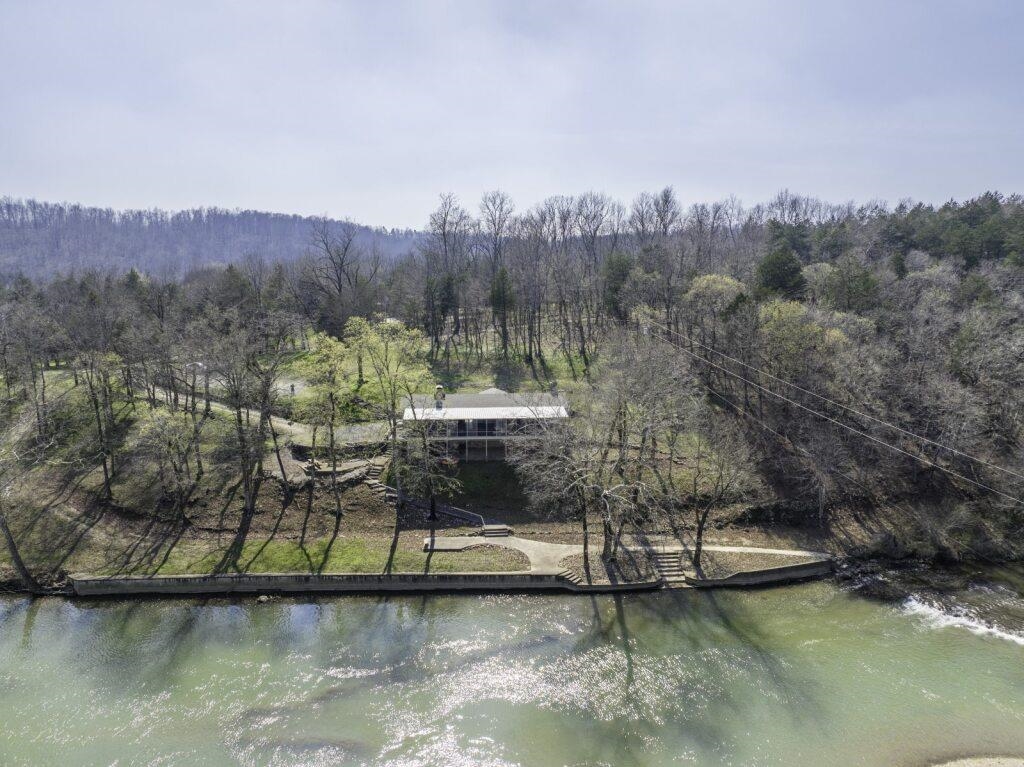 262± acre & country home for sale with long frontage on the Spring River in the Ozarks of northern Arkansas. This unique property sits directly on the banks of the river with magnificent views from every bedroom, creating a true waterfront living experience.  The 3-bedroom, 2-bath home comes fully furnished, making it move-in ready for a full-time residence, weekend getaway, or hunting lodge. Enjoy the sights and sounds of the river & its waterfalls from the screened-in porch that stretches across the front of the home. The beautifully remodeled kitchen comes complete with new stainless steel appliances.  This recreational property for sale in Sharp County, AR features mostly woods, with small areas of pasture used as food plots along the creek that runs through the property, providing excellent deer and turkey habitat. Established ATV trails and marked paths throughout much of the property provide access across portions of the acreage.  Located in the heart of 'Spring River Country' in Hardy, AR, near the Spring River and South Fork River. Lake Thunderbird, Lake Sequoyah, Lake Cherokee, Lake Omaha, and Lake Sherwood are located within 20 minutes for year-round recreation.