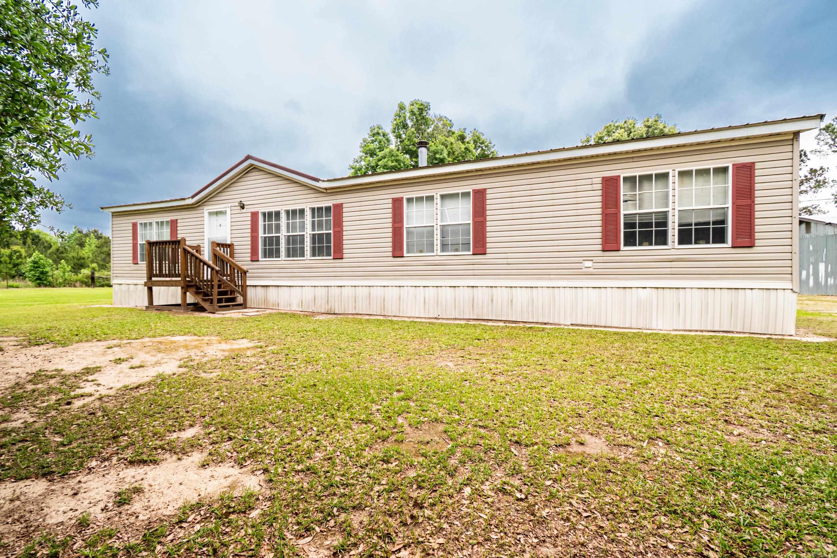 Spacious 4-bedroom, 2-bath mobile home offering approximately 1,800 square feet of comfortable living space! This home features a kitchen with a center island that opens seamlessly into the dining area. Enjoy a living area and a functional layout that includes a laundry room with convenient access to the backyard. Outside, you’ll find a shed along with a separate shop, providing plenty of space for storage and other projects. A great blend of space, functionality, and versatility!”