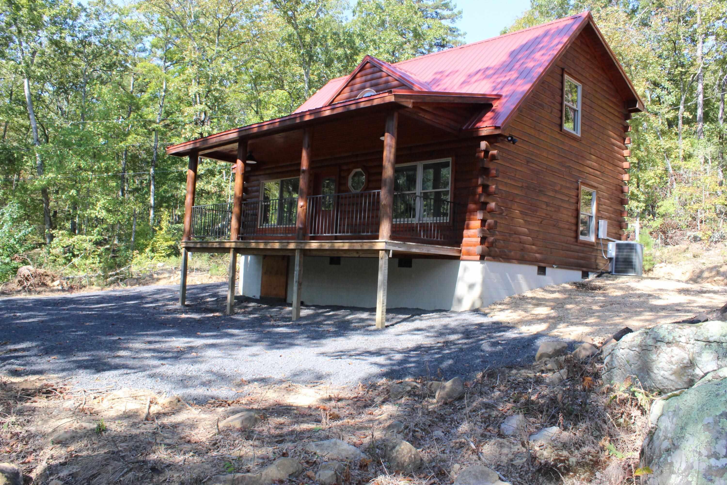Cozy log cabin nestled on 20+/- acres of pristine recreational timberland, perfect for hunting enthusiasts and nature lovers alike. Overlooking the  Middle Fork of the Little Red River, this tranquil retreat offers a peaceful setting in the heart of the Ozark Mountains. Numerous rock features scattered throughout the property. Cool off in your very own swimming hole. New appliances 2024 & a whole house water purification system 2025. Inside, has an inviting atmosphere, ideal for unwinding after a day of adventure. With fiber internet, you can stay connected while enjoying the serenity of rural life. With wildlife consisting of whitetail deer, bear, turkey, and numerous small game animals makes this property a haven for avid hunters. Nearby is the Buffalo National River where you can enjoy kayaking, canoeing, fishing, and numerous other outdoor activities. 13 miles to Marshall, AR, where you can gather your day-to-day supplies.  With electric and septic behind the cabin already in place this area would offer ample space for another dwelling or shop. Whether you are looking for a weekend getaway or that forever home this could be just what you have been looking for! Don't Miss Out!!!