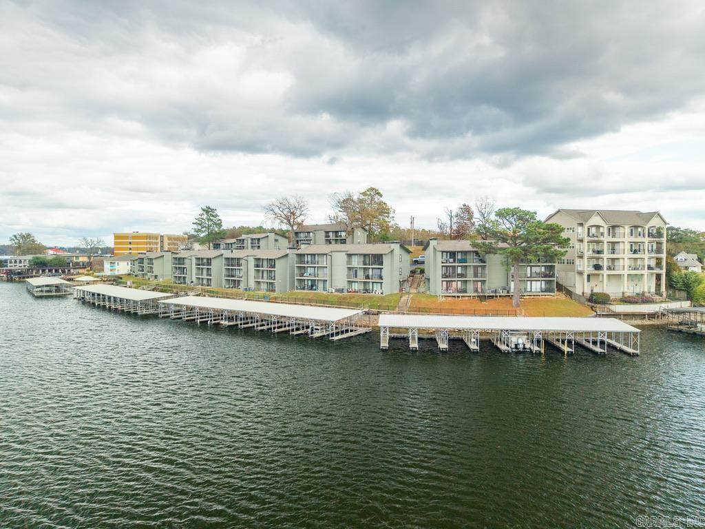 Welcome to 120 Catalina Circle, a gated, lakefront WALK-IN LEVEL 2-bedroom, 2-bath condo offering incredible main-channel views of Lake Hamilton. With 1,104 sq. ft. of well-designed space, this unit features an open layout, spacious bedrooms, and a private covered boat slip included.  Enjoy resort-style amenities including a swimming pool, pickleball courts, and community areas—all within a low-maintenance, waterfront setting.  Whether you're searching for a full-time home or a weekend lake retreat, this condo delivers the best of lake living—views, convenience, amenities, and comfort.  Boat slip included • Prime lakefront location • Low-maintenance lifestyle
