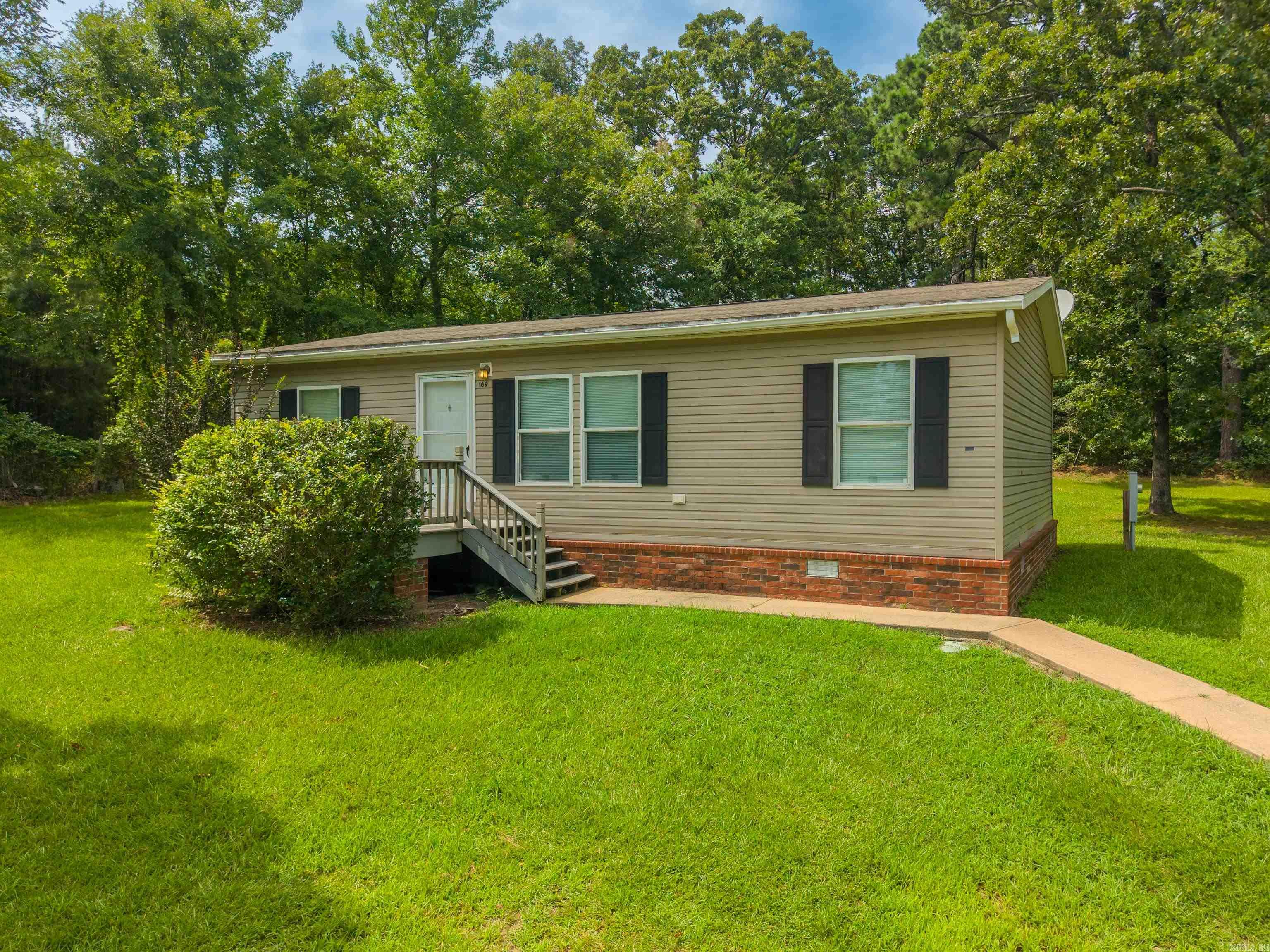 Charming Modular Retreat on 1.4 Unrestricted Acres! Welcome to 169 Medford Road in peaceful Pearcy, AR — where privacy meets convenience. This 2016 modular home sits on a permanent foundation and offers 3 bedrooms, 2 baths, and a functional, comfortable layout perfect for everyday living. The 1.4-acre lot is cleared and unrestricted, giving you room to spread out, garden, or bring your animals and toys — the possibilities are endless. A cute storage shed sits conveniently beside the home for extra space to organize your tools and outdoor gear. Tucked away with no neighbors in sight, this property offers the peace and quiet you’ve been searching for, without sacrificing accessibility. Don’t miss this rare opportunity to own unrestricted acreage with a solid, move-in-ready home. Schedule your showing today!