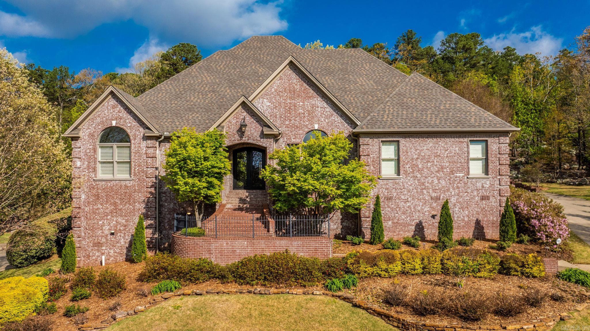Custom-built home in the desirable LaMarche Place community of Chenal with numerous updates and exceptional amenities. New roof in 2024, fresh interior paint in 2026, main HVAC replaced in 2023, upstairs HVAC replaced in 2018, and quartz countertops added in the primary bath and hall bath in 2026. Spacious upstairs in-law suite offers private laundry, kitchenette, and dishwasher. Whole-house generator and tankless water heater. Hardwood floors downstairs in living areas as well as plantation shutters throughout. Nugget ice maker, Wolf double oven and Viking range top. Professionally landscaped with a large stamped concrete patio backing to peaceful green space. Stairlift conveys or can be removed. Subzero refrigerator does not convey.