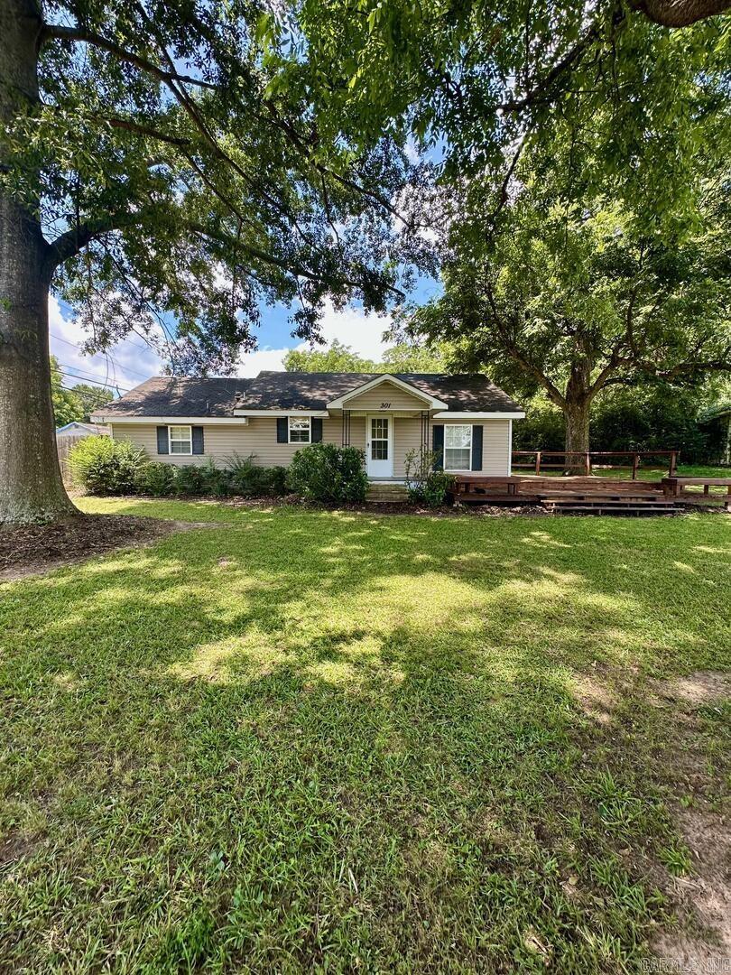 Great Investment Opportunity! This 2 bedroom and 1 Bath Home sits on a corner lot just a block from Sheridan Schools. This fully vinyl sided home with replacement windows offers a large wrap around deck and a 6' wood privacy fence on the side yard. Also, an attached one car carport with additional parking pad area. This Home has tons of potential! Property being sold AS-IS.