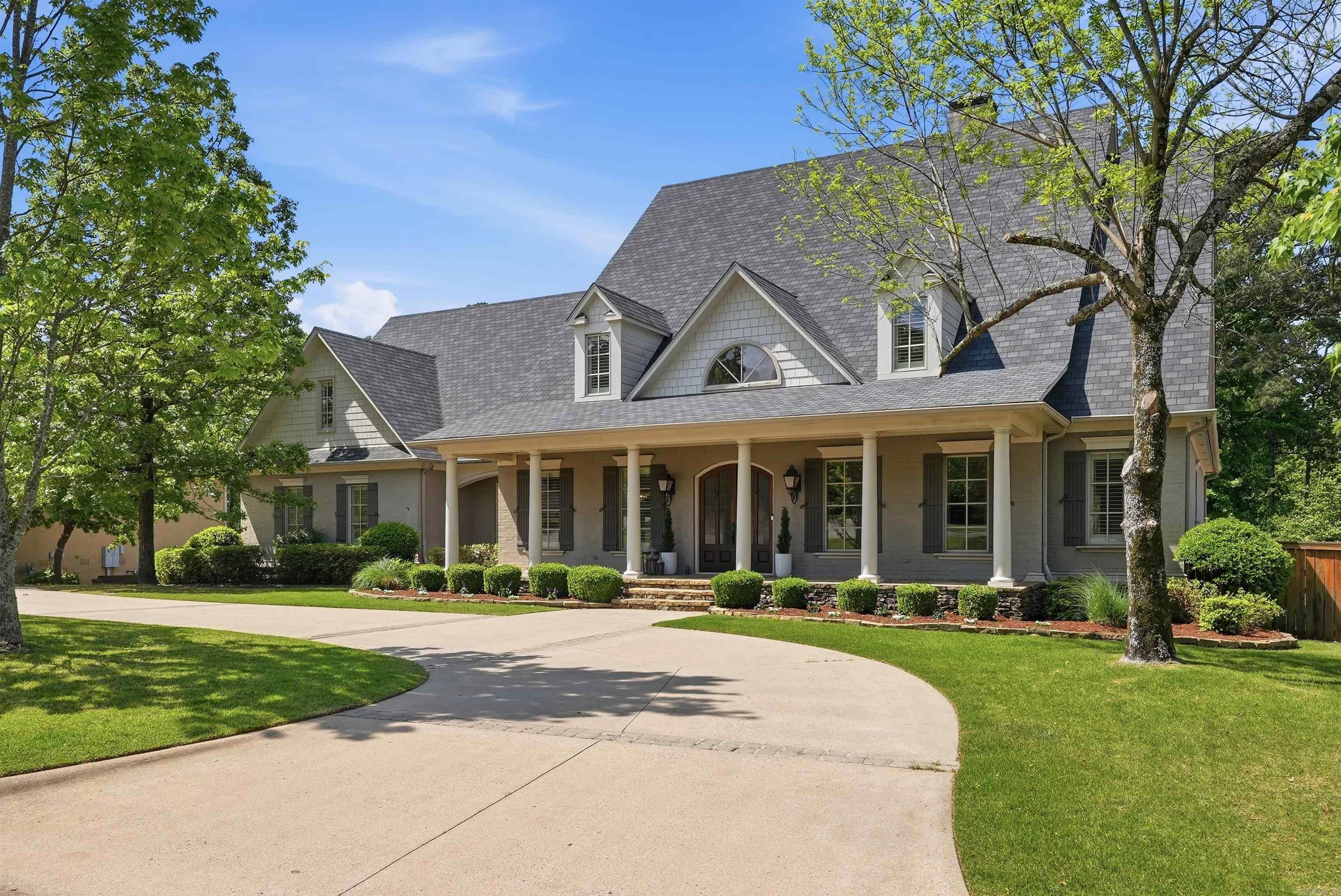 Behind the private gates of Germay Court, this Kevin Hughes custom home is positioned on the 5th fairway of the Bear Den Golf Course, offering an oversized lot and cart-path access to Chenal Country Club. A charming front porch welcomes you inside to the foyer that is anchored by an office w/ oak-stained woodwork & built-ins and a formal dining room w/ a nearby wet bar. The great room features a gas fireplace with Italian marble mantle, built-ins & access to the covered back porch. The remodeled gourmet kitchen includes fresh updates and premium appliances, making it a chef’s delight. Additional main-level features include a breakfast area, pool bath, half bath, pantry w/ coffee bar, laundry room & mudroom. The main-level primary suite is a peaceful retreat & includes an ensuite bath with dual vanities, a jetted tub, walk-in shower, water closet & walk-in closets. Upstairs offers a game room w/ kitchenette, hangout room, guest suite with private bath & 2 additional bedrooms that share a hall bath. The backyard is designed for entertaining with covered & open patios and a renovated gunite pool & spa. A three-car garage, workshop, and circle drive complete this exceptional property.