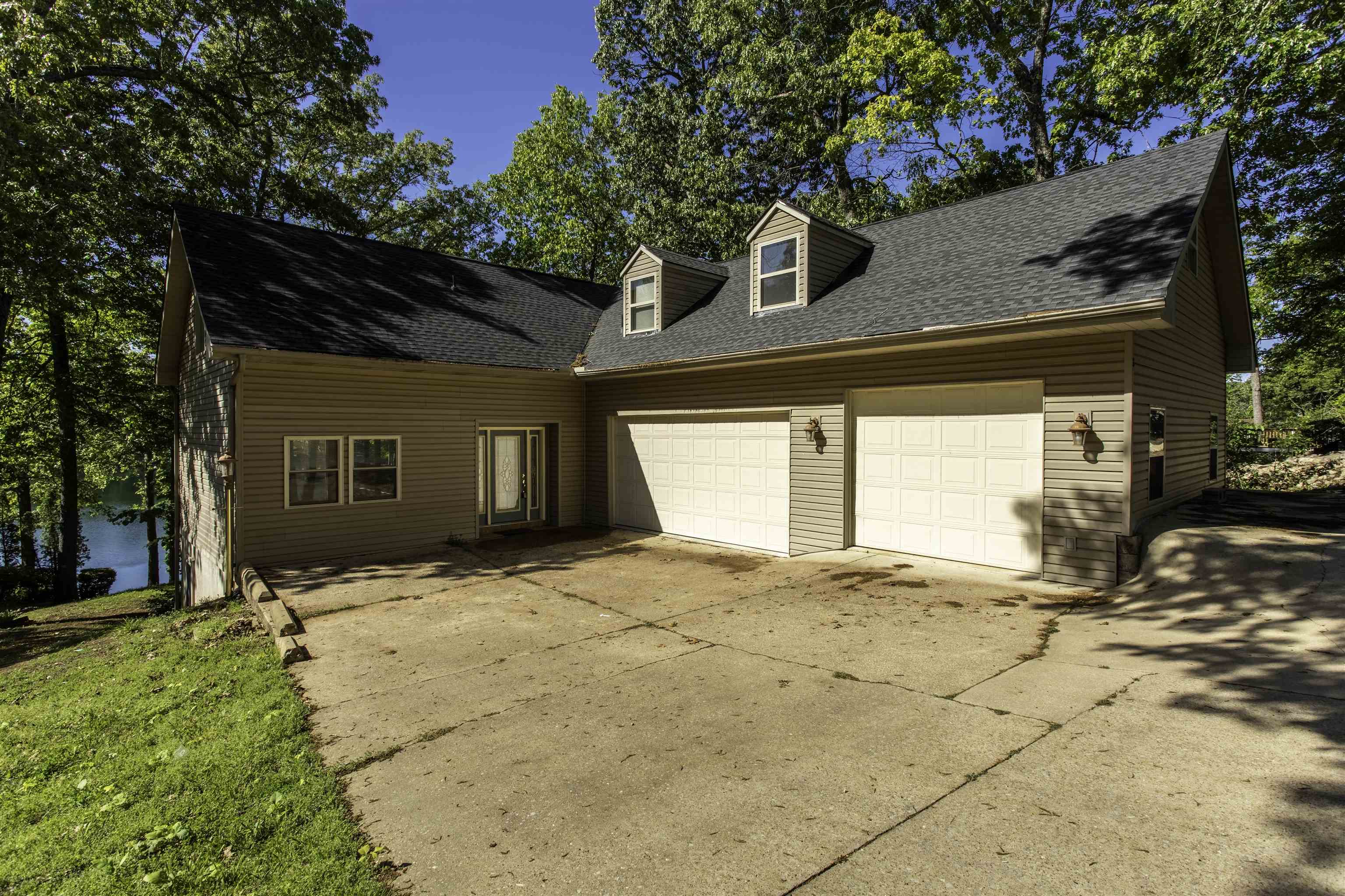 Beautiful 3BR/3 bath home on Lake Thunderbird! 3 car garage/shop with extra parking. Prime location on Lake Thunderbird, on quiet cul de sac. Upstairs you will find the primary suite with balcony view of the lake. Large primary bathroom has 2 pedestal sinks, soaking tub and shower. Laundry facilities on this level for convenience. 2nd Bedroom also on this level with large walk in closet. All new flooring upstairs. On the main level there is another bedroom with walk in closet and private bath. Hardwood and tile flooring in living room, dining room and kitchen. Lower level walk out basement has another area that could be office or sewing rm, another bathroom, family room with tile floor. Separate room with sauna, plus storage area. Outdoor areas to enjoy include deck, patio and seawall area perfect for fishing or soaking up the sun. Prime lakefront spot on Thunderbird.