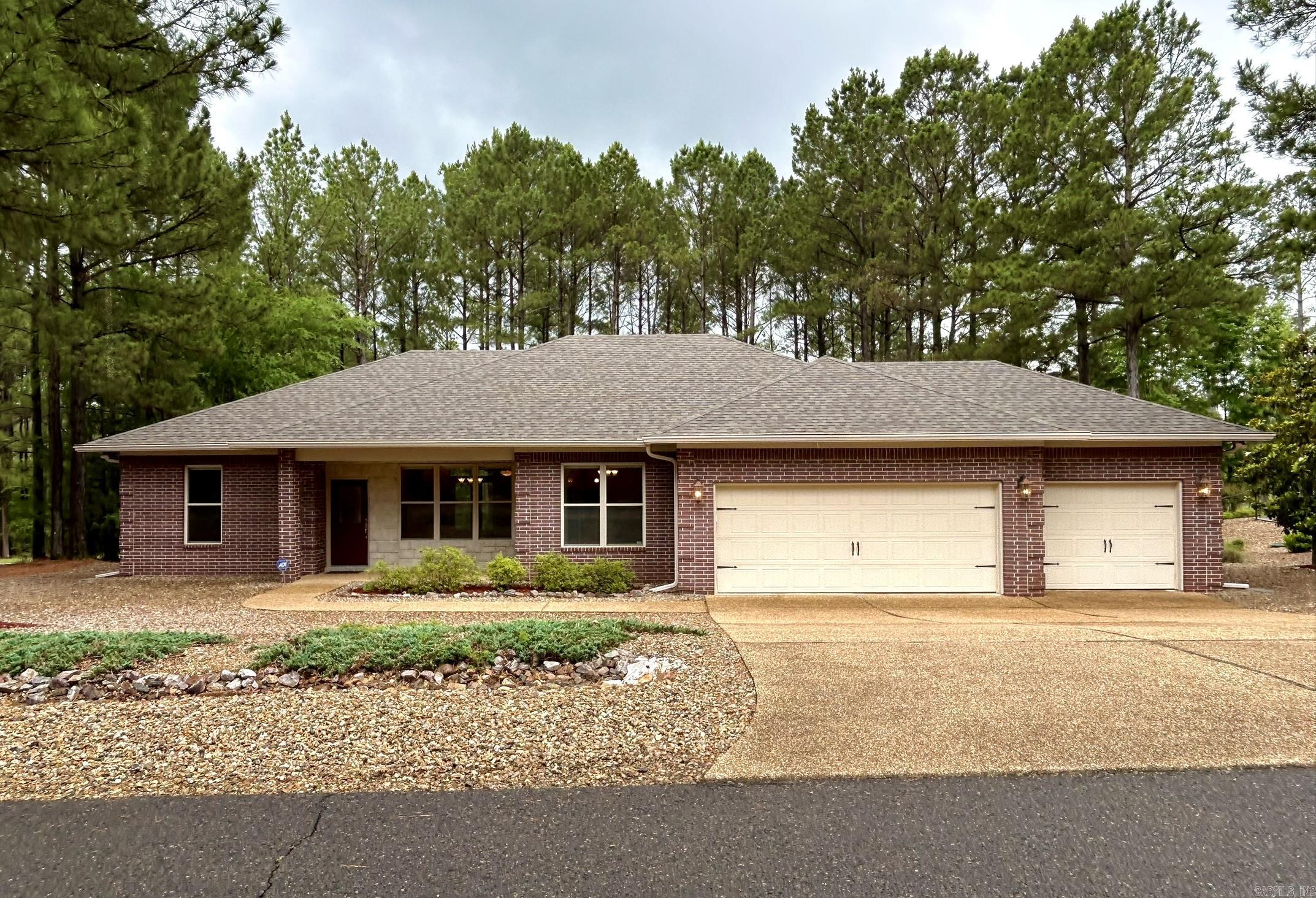 Fantastic East Side location less than one mile from the East Gate! This beautifully maintained, updated home features an all-masonry brick and stone exterior, coveted 3-car garage, and low-maintenance landscaping so you can spend more time enjoying golf, fishing, and all the Village amenities.  Inside, you’ll find an open-concept split floor plan with 9’ ceilings, crown molding, recessed lighting, ceiling fans, and neutral color palate. Engineered hardwood flooring in the main living areas, tile in the kitchen, and new carpet in the bedrooms add warmth and comfort. The kitchen offers granite countertops, stainless steel appliances including double ovens, and opens to the living area with a gas log fireplace.  The spacious primary suite includes a huge walk-in closet, jetted tub, and walk-in shower. Step outside to a private covered patio with ceiling fan and lighting overlooking a fully fenced, beautifully forested backyard complete with a lovely rose garden.