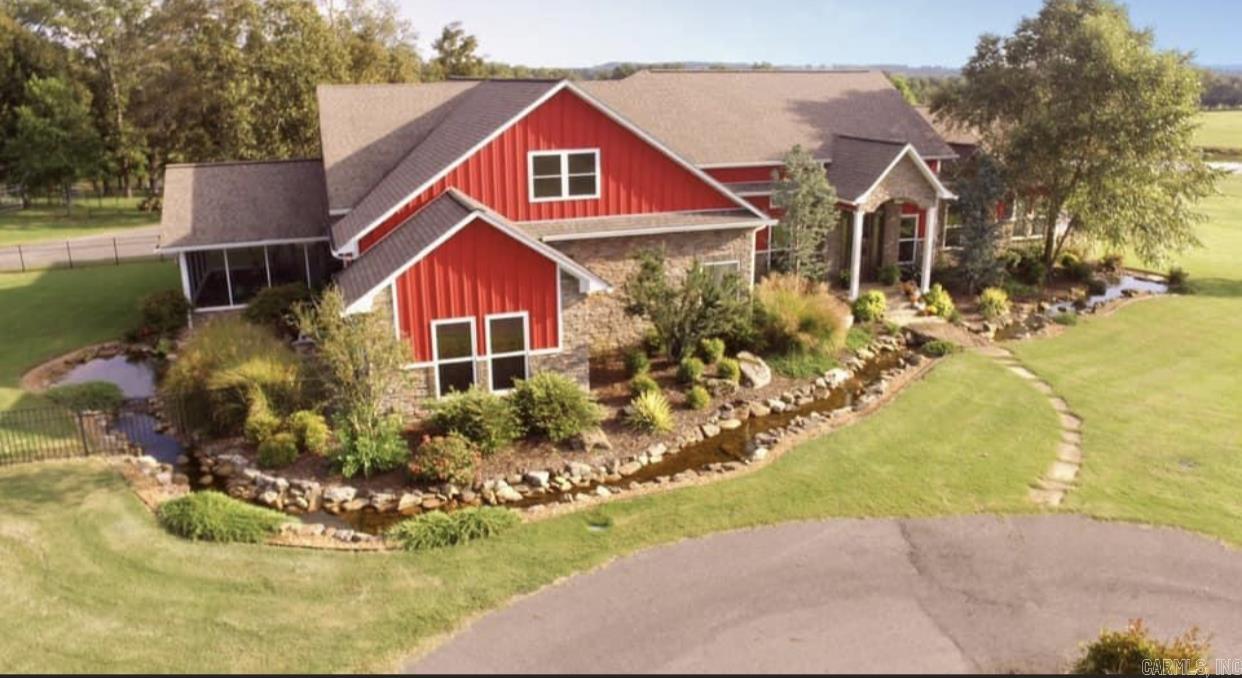Welcome to your dream ranch — Come through a gated entrance to a stunning 5436 sq ft luxury residence set on 252 rolling acres of prime land, thoughtfully designed for both upscale living and equestrian or cattle operations. This rare offering combines timeless elegance, functional ranch infrastructure, and modern convenience in one extraordinary package. Some features are 5 bed/5.5 bath that boast 2 primary suites, large office, pantry, laundry room, formal dining room, windowed sun room and a separate screened-in porch. Additionally, this kitchen is a chef's dream with an island perfect for entertaining, upscale GE Monogram appliances, and custom cabinetry. Outside you'll find a beautiful saltwater pool, hot tub, covered patio, superb landscaping, 7 stall barn with lots of extras, covered arena, roping arena, shop, equipment barn, ponds in every pasture, and 2 bd/1 ba guest house or rental apartment!  See agent remarks for extensive features list.  Charming 1305 sq ft 2 bed / 1 bath barndominium, ideal for guests, ranch hands, or rental income is tucked away on the backside of the property. It has a balcony with views of a pond and most of the pastures.