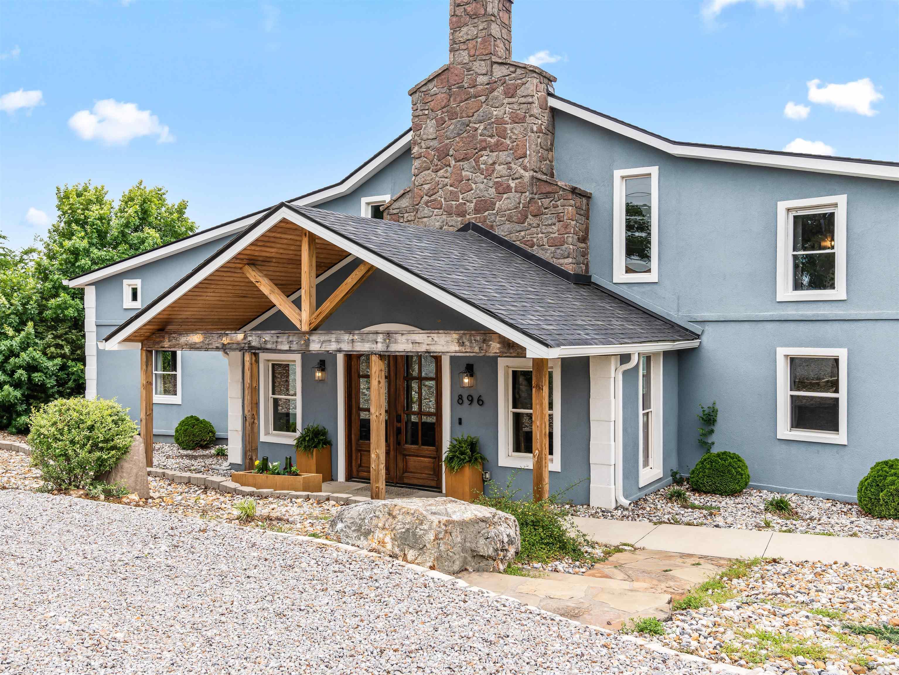 Perched atop Mt. Riante with sweeping views of Lake Hamilton and the Ouachita Mountains, this 7,300 sq ft, 7-bed/5.5-bath estate spans three levels, each with its own private deck. Bold teal chef's kitchen, floor-to-ceiling stone fireplace, 12-person dining room wrapped in lake-view windows, spa primary suite with jetted tub overlooking Lake Hamilton, game room, pool table, bunk room, and a covered hot tub under string lights. What sets this apart: mini-split HVAC keeps average electric at just $339/month on 7,300 sq ft. Well and septic mean zero city utility bills. County property taxes just $7,679/year — and no city tax. Active STR with proven revenue. Listed below appraised value-appraisal completed March 2026. Sold fully furnished. Lakeside School District. Gated community. $1,200/yr HOA covers road, gate, and dumpster. STR data available upon request.
