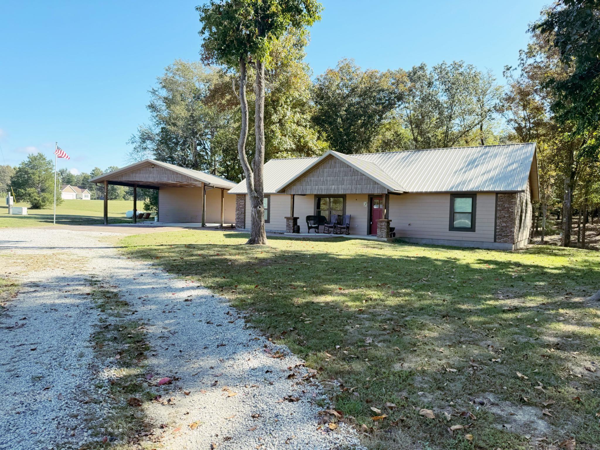 This 1,797 sq ft property offers a great setup on 6.3 acres just outside of town. The main home features 1,557 sq ft with 3 bedrooms, 2 bathrooms, an open floor plan, vaulted wood ceilings, a stone fireplace, and new flooring throughout.  The kitchen has stainless steel appliances, solid wood cabinetry, and plenty of counter space. Out back, you’ve got a peaceful porch overlooking a koi pond with a waterfall—an easy spot to relax and enjoy the setting.  You’ll also find a 2-car carport with a finished 240 sq ft space that includes two rooms and a half bath. This works well for a guest space, office, craft room, or even a small in-law setup. Storage shed included, plus a whole house generator already in place.  If you’re wanting acreage, usable space, and something that’s move-in ready without feeling crowded, this is a solid option.