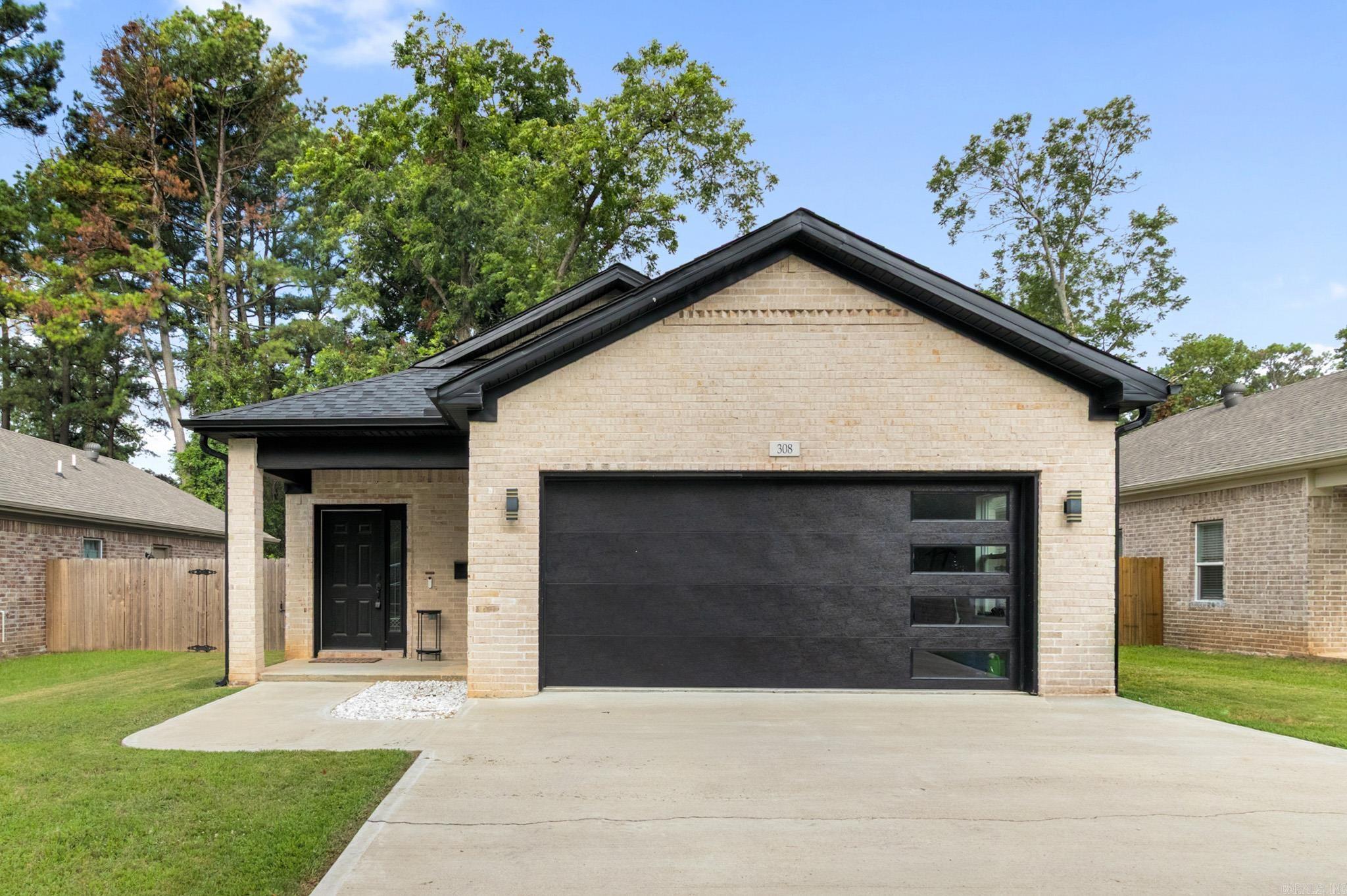 STUNNING MODERN LIVING IN LONOKE! PRICED TO SELL AT $220,000!  Welcome to 308 Frank T. Bunton Rd, where small-town charm meets modern luxury! This gorgeous 3-bed, 2-bath, 1,423 sqft all-electric home is 100% move-in ready.  Step inside to a bright, open floor plan built for easy living. The heart of the home is the dream kitchen, loaded with tons of cabinet space, premium granite countertops, an electric stove, and a massive island perfect for meal prep or casual morning coffee.  Both bathrooms feature custom-tiled showers and tile floors, adding a high-end, luxury feel. Complete with a spacious 2-car garage, this home beautifully balances convenience and efficiency.  THE LOCATION: Nestled in peaceful Lonoke, you are just a short drive from Little Rock and Cabot! Enjoy quiet, small-town living while being seconds away from local restaurants, the library, parks, and walking trails.  This energy-efficient gem is priced to sell and won't last long. Schedule your private tour today!