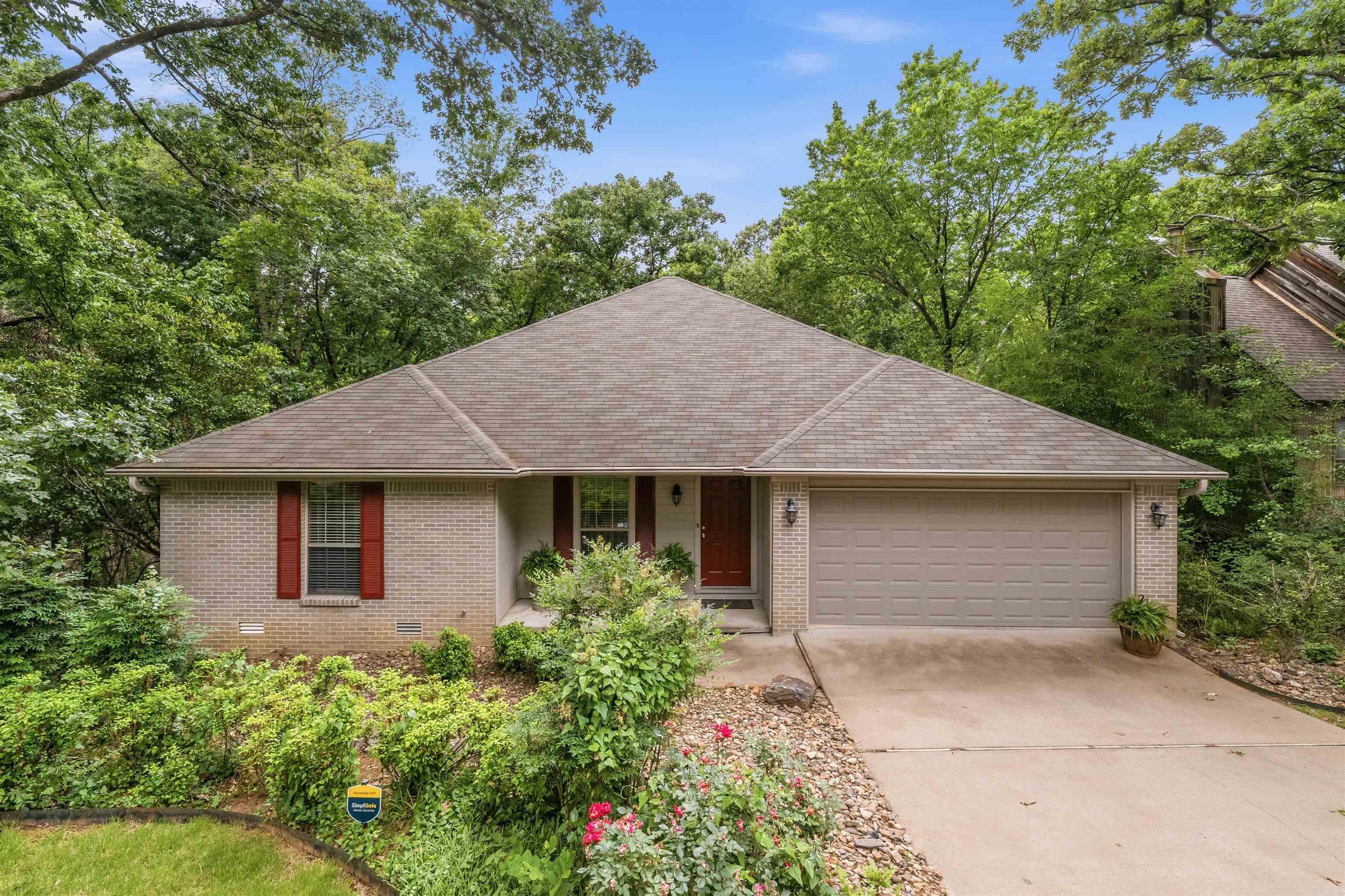 Location, location, location! You will love this single-story home in the heart of Lakewood with convenient access to restaurants, shopping, & interstates. It's even walking distance to Lakewood Elementary. This one-owner home welcomes you with a foyer that opens into the great room where a wall of windows across the back creates a true treehouse feel with peaceful views of the treetops. The great room features wood floors, tall ceilings, & a corner fireplace that adds warmth & character. Off the living area you will find a formal dining room perfect for gatherings. The kitchen offers solid surface countertops, ss appliances, a breakfast area, & a large window overlooking the backyard. The primary suite is tucked away on the backside of the home for added privacy & has a spacious en-suite with double vanities, his/hers closets, a tub, & separate shower. There are two additional bedrooms with one offering double doors to the foyer making it ideal for a home office if desired. A standout features of this home is the sunroom. Surrounded by backyard views, it is the perfect place to relax and unwind. Step outside onto the large deck that overlooks the backyard which is green space.