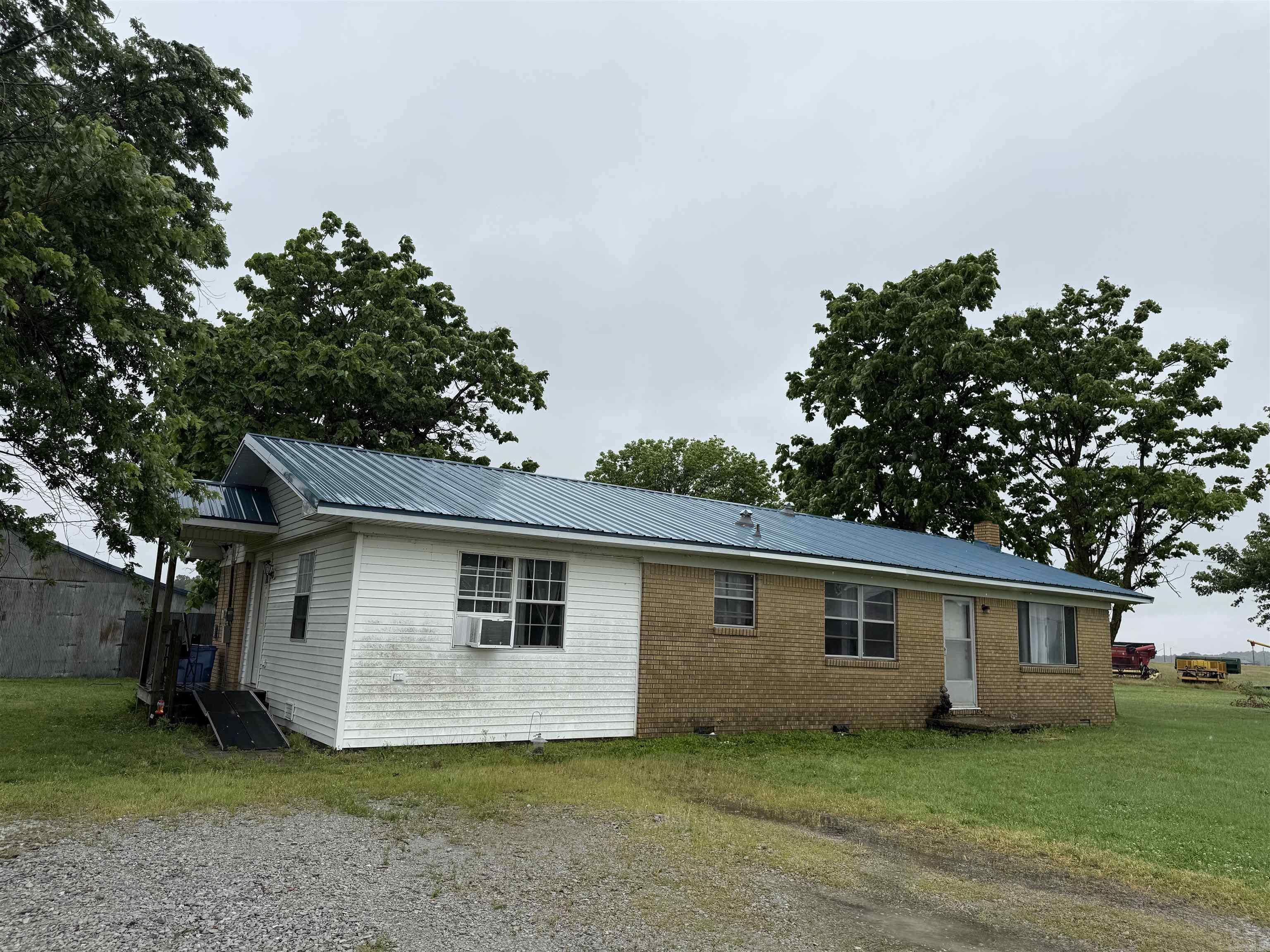 Charming country home situated on 1 acre with plenty of potential! This 4 bedroom, 2 bath home features some original hardwood floors and offers a peaceful rural setting. Both the home and the outdoor storage building have newer metal roofs for added durability and value.  Calling all investors or buyers looking to add to their rental portfolio! Please note that this property will not qualify for FHA, RD, or VA financing. Although it has a Walnut Ridge address, the property is located in Greene County and is conveniently situated just 18 minutes from Walmart in Paragould. Don't miss this opportunity to own an affordable country property with room to make it your own!
