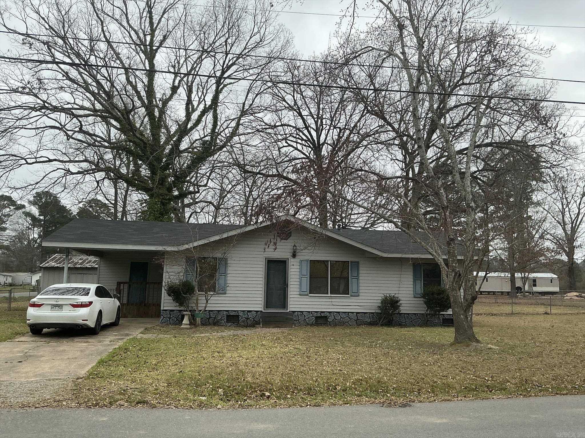 If you are looking for a Move-in-Ready, great starter home, or a great home to retire to, this is the home for you.  It features a galley kitchen with stove and open to the dining area.  The living room is also open to the dining room, and the hall leads to the 3 bedrooms and hall bath featuring shower over the bathtub.  The laundry room is located in laundry room off the one car carport.  Home is all electric and has central unit with new thermostat, and the roof was replaced December 2025.   If you are looking for a large fenced in yard for a garden, this home is for you and is located on a corner lot with double gates for easy access to the backyard.  Seller has also left some furniture and a clothes dryer that will remain with the property if buyer wants them. (Seller is selling "as is")  House will qualify for FHA and USDA-RD.