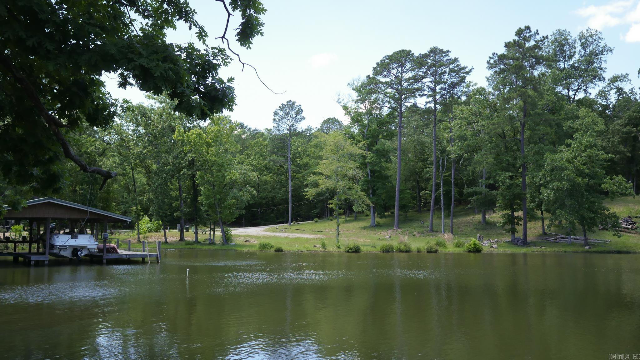 129 Ft of Lake Hamilton Waterfront | Build-Ready .75-Acre Lot | Hot Springs, AR  Rare opportunity to own 129 linear feet of pristine Lake Hamilton frontage on a beautiful 0.75-acre lot in Hot Springs, Arkansas. This cleared, build-ready parcel features a gorgeous mix of mature trees and open space — the perfect canvas for your custom lake home, weekend retreat, or vacation rental investment.  The hard work is done: working septic, electric at the lot, fiber optic internet on property, and public water available at the street. Bring your builder and your blueprints.  Lake Hamilton is central Arkansas's premier recreational lake — world-class bass fishing, waterfront dining, boating, and tubing. Minutes from Oaklawn, Hot Springs National Park, and Central Ave dining and shopping. Host of 2026 World Bass Fishing Championships.  Located in the highly regarded Lake Hamilton School District.  Additional lots available — ask about the full package of three.  Buyer retains mineral rights. New construction only — no trailers, mobile, or modular homes. No RV restrictions, no time limit on RV stays — bring your RV and enjoy lake life while you plan and build your dream home.