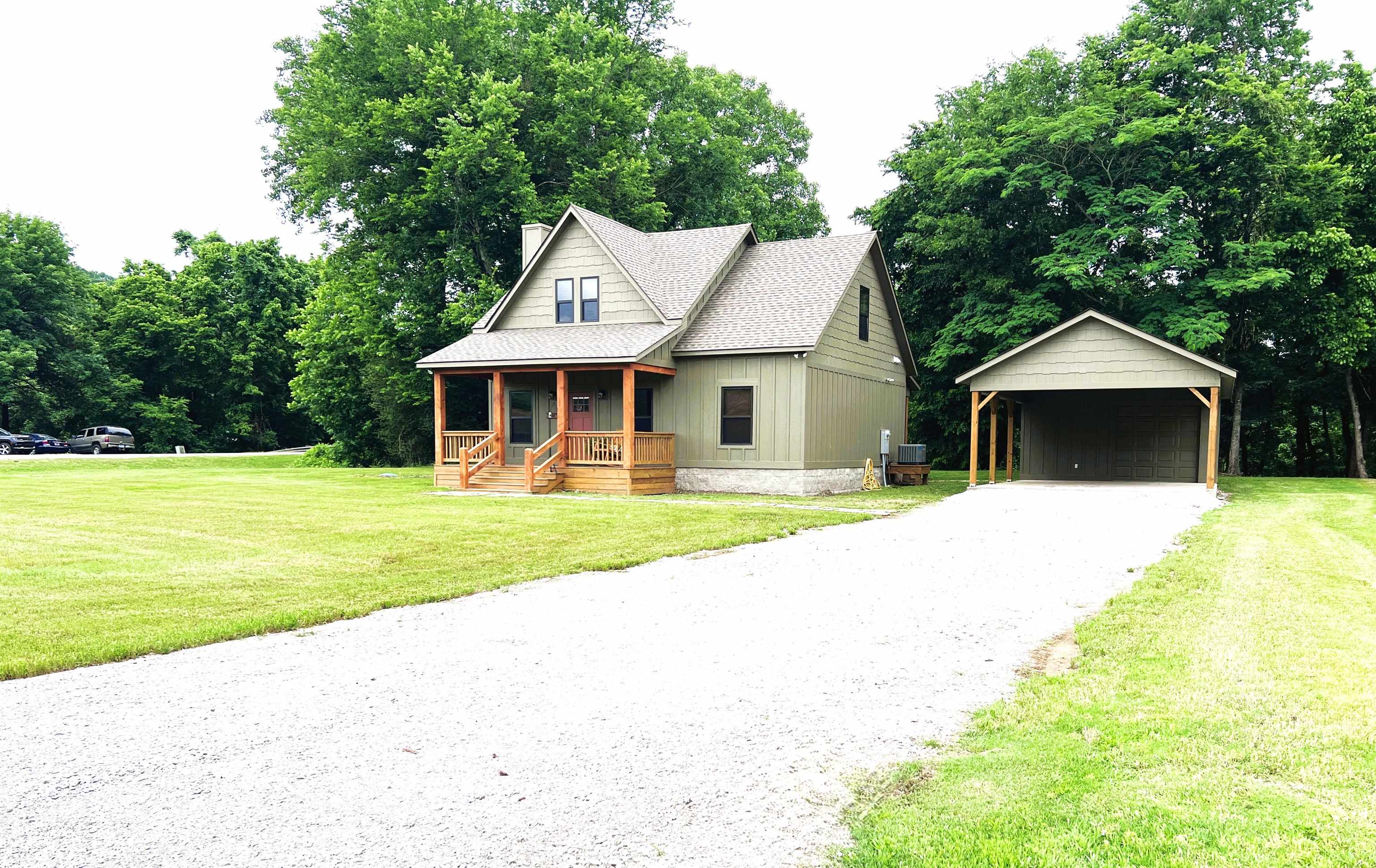 New construction in the Ozarks with White River frontage and modern rustic charm! This fully furnished 3 bed, 2.5 bath home offers approx. 1,700 sq ft of thoughtfully designed living space just minutes from downtown Mountain View and the outdoor recreation the area is known for. Nestled on a covenant protected street, this is the last exclusive home available in this desirable White River setting. Built with quality craftsmanship and attention to detail, the home features warm wood countertops, gas range, tankless water heater, Low-E insulated windows, wood accents, and an open-concept layout ideal for gathering with family and friends. The spacious kitchen offers abundant prep space, breakfast bar seating, and additional storage beneath the staircase. Enjoy what sets this home apart — the only property in the development with a deck ready for grilling, relaxing, and taking in your very own White River frontage. Additional features include screened porch, detached carport, storage/shop area, paved road access, public water, and move-in ready convenience. Community covenants preserve the quiet character of this exclusive river setting by prohibiting nightly and short-term rentals.