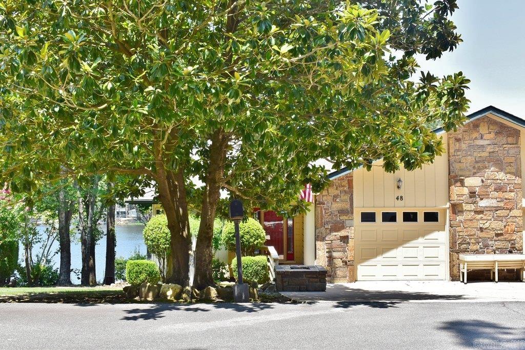 Experience the ultimate lakeside escape in this charming duplex townhouse, perfectly positioned on a peaceful fishing lake. The bright, spacious great room flows seamlessly into a stunning sunroom, boasting vaulted ceilings, an atrium window design, and an abundance of natural light. An efficient, updated kitchen features premium granite countertops and a cozy breakfast nook. Designed for effortless main-level living, the entry floor hosts the primary bedroom suite, kitchen, and laundry room, while the lower-level guest quarters offer ultimate privacy for visitors. Enhanced with major structural updates—including a newer roof, a 2024 HVAC system, and modern luxury vinyl plank (LVP) flooring—this home is move-in ready, yet awaits your final touch. Step into your backyard to discover a true outdoor paradise, complete with a private boat dock. Come see it in person to truly feel the magical sense of relaxation this property offers!
