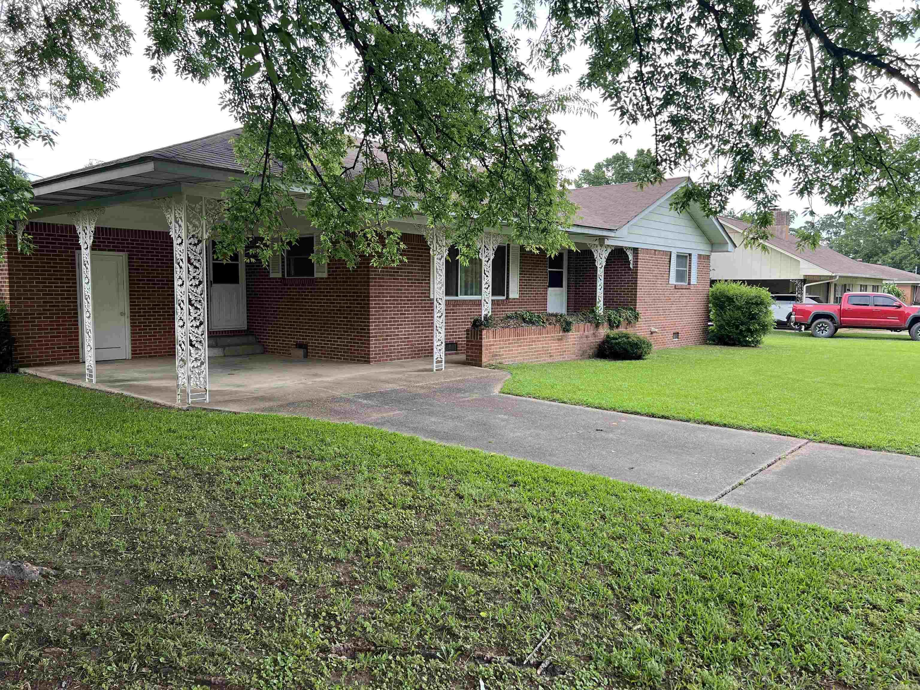 Charming all-brick home on a spacious .36-acre lot with room to spread out! This home features a huge kitchen, oversized living room, coffee bar, wall oven, separate laundry room, hardwood floors, and two full baths. The flexible layout offers plenty of space and could easily allow for a third bedroom. Enjoy lots of natural light throughout, a massive backyard, and a two-car carport with outside storage. Conveniently located minutes from I-30 and close to shopping, dining, and everyday amenities.