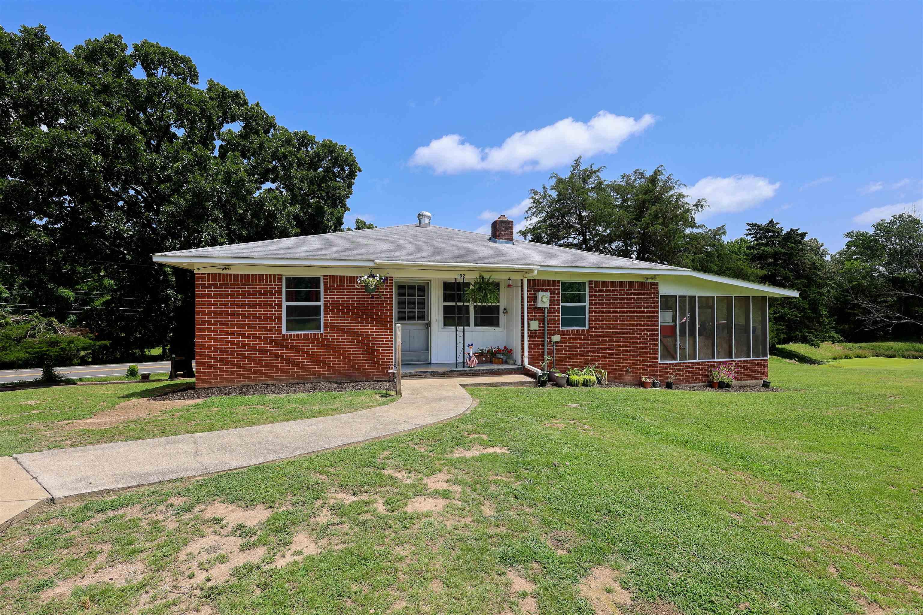 Classic brick home with room to spread out! Situated on approximately 1.67± acres in the heart of Mount Ida, this 3-bedroom, 2.5-bath home offers over 1,500± square feet on the main level, plus additional finished living space in the walk-out basement, providing flexibility for a second living area, recreation room, home office, or hobby space. The spacious layout features generously sized rooms, abundant storage, and timeless character throughout. Step outside to enjoy the patio overlooking the backyard, complete with a pond, and plenty of room for gardening, outdoor entertaining, or simply enjoying the setting. Conveniently located in town with the space and feel of a larger property, this home offers a unique opportunity to make it your own.