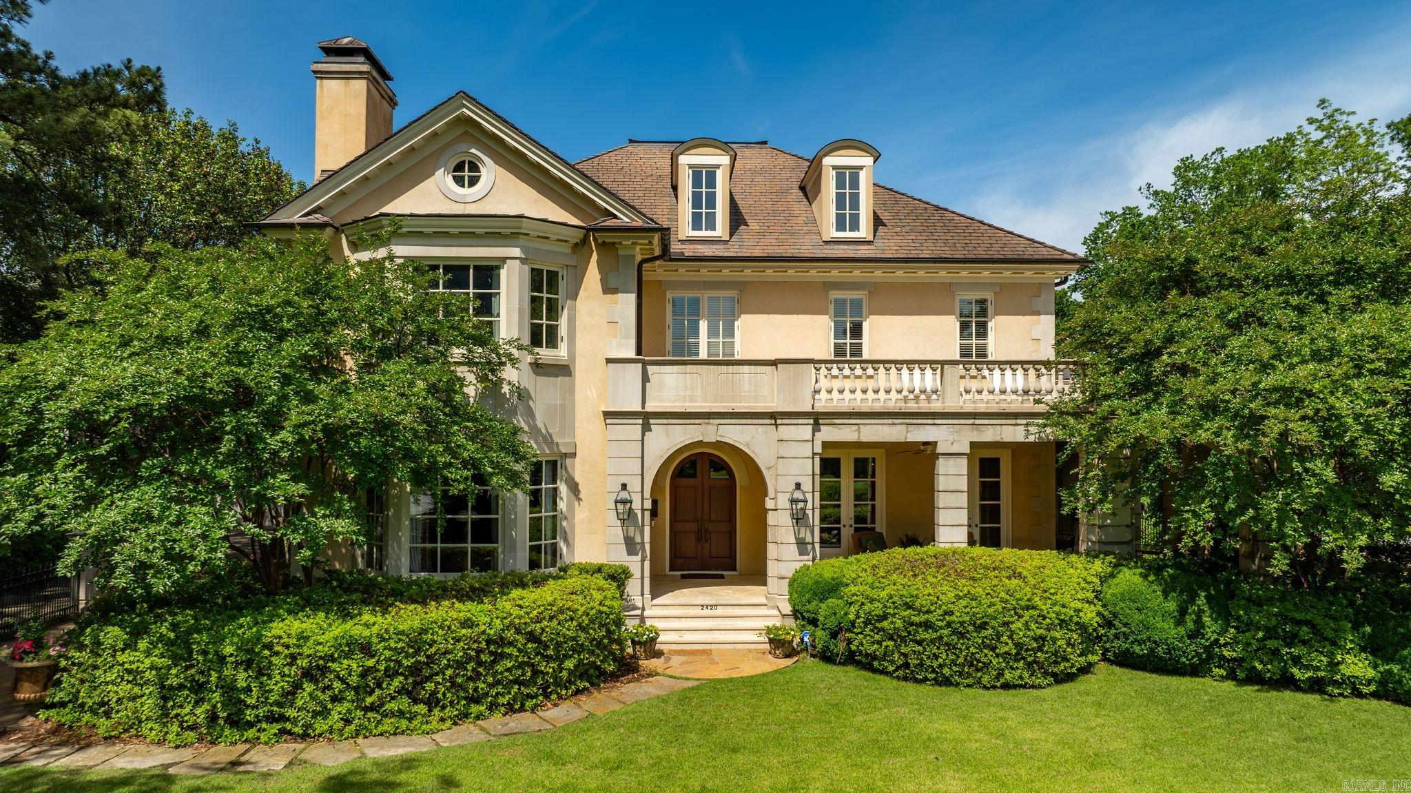 A perfectly positioned Heights home across the street from the Country Club of Little Rock golf course. This residence was built by Jack Hartsell in 1998-99 and pairs timeless architecture, thoughtful large living spaces, wonderful windows and light, all creating a home that is elegant and inviting. The primary bedroom suite is upstairs with two private primary bathrooms and large walk in closets. Watch golfers head out to Hole 10 or the driving range from the upstairs balcony or front porch! All bedrooms are ensuite with nice sized closets. Two guest suites accompany the primary upstairs, and there is a guest suite on main level. Lower level adds 1595 square feet and all the fun - wine room, exercise space, large office and living space with fireplace, refreshment station, full bath, storage, and pool table space. Bonus 625 feet over the garage with a full bath, bedroom and storage.  The beautiful exterior is a stucco layer on top of brick, roof is synthetic slate. This is a special, well maintained home on a large, 100 foot flat lot with two car garage, golf cart bay and large generator. One of 11 houses that overlooks The Country Club of Little Rock golf course.