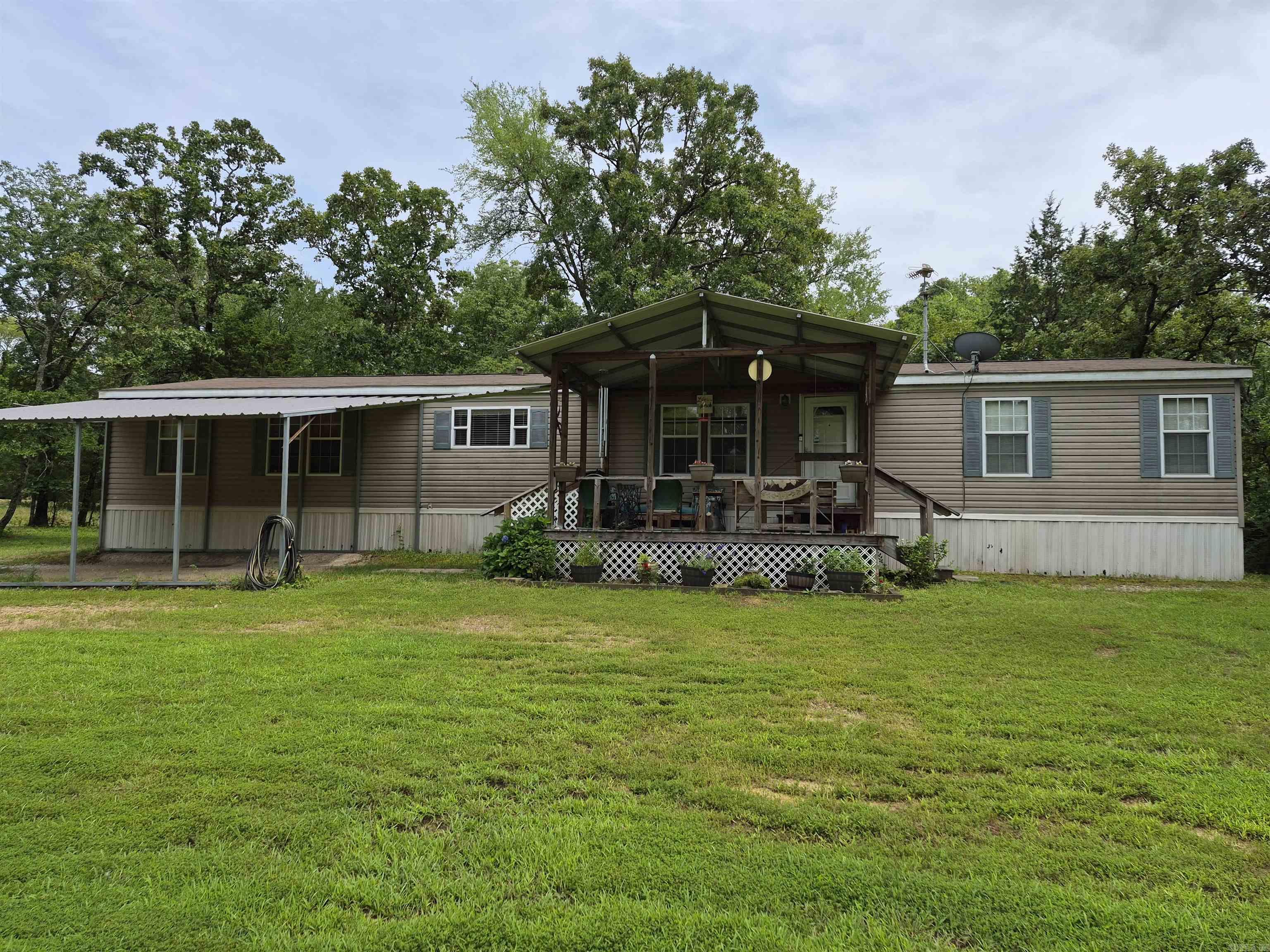 Looking for acreage right outside of town?  This is it!  Beautifully maintained doublewide home with 4 bedrooms, on 10.7 acres!  This property has wooded areas for hunting and a rich soiled flat land for gardening or animals.  The roof was replaced in 2018, new septic lines in 2023, new water heater and new luxory vinyl in the kitchen, utility and baths.  Make your appointment today to see this property!