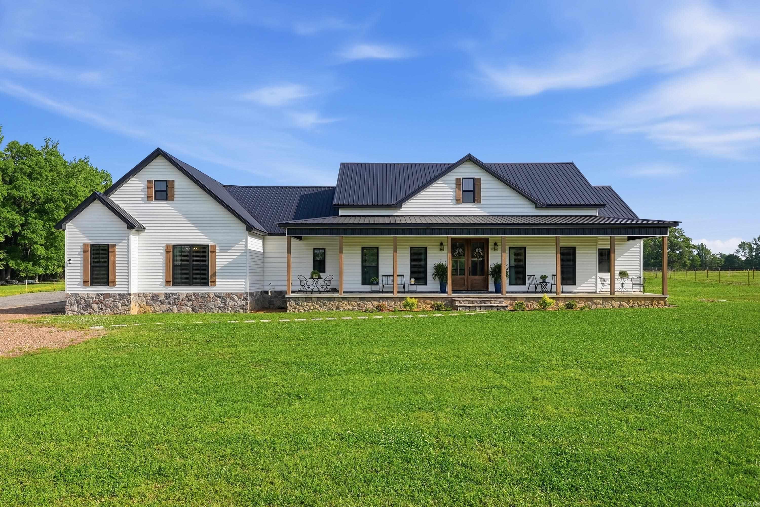 Wow, this custom-built property in desirable Wooster is a stunner! Featuring a main home offering 4 bedrooms and 2 bathrooms. The heart of the home is an expansive open-concept living, dining, and kitchen area spanning over 1,000 sq ft, highlighted by a cozy fireplace and vaulted ceilings. The kitchen is designed to impress with dual islands, granite countertops, and a large walk-in pantry. A separate guest house provides excellent flexibility with 1 bedroom, 1 bathroom, a safe room, and an attached garage—ideal for guests, extended family, or rental potential. Both homes include screened-in porches, tankless water heaters, and individual septic systems. The included 5 acres is ready for country living with plenty of space for horses or livestock, plus a chicken coop. If you’ve been looking for a move-in ready property with room to spread out that you'll never want to leave, this one checks all the boxes.