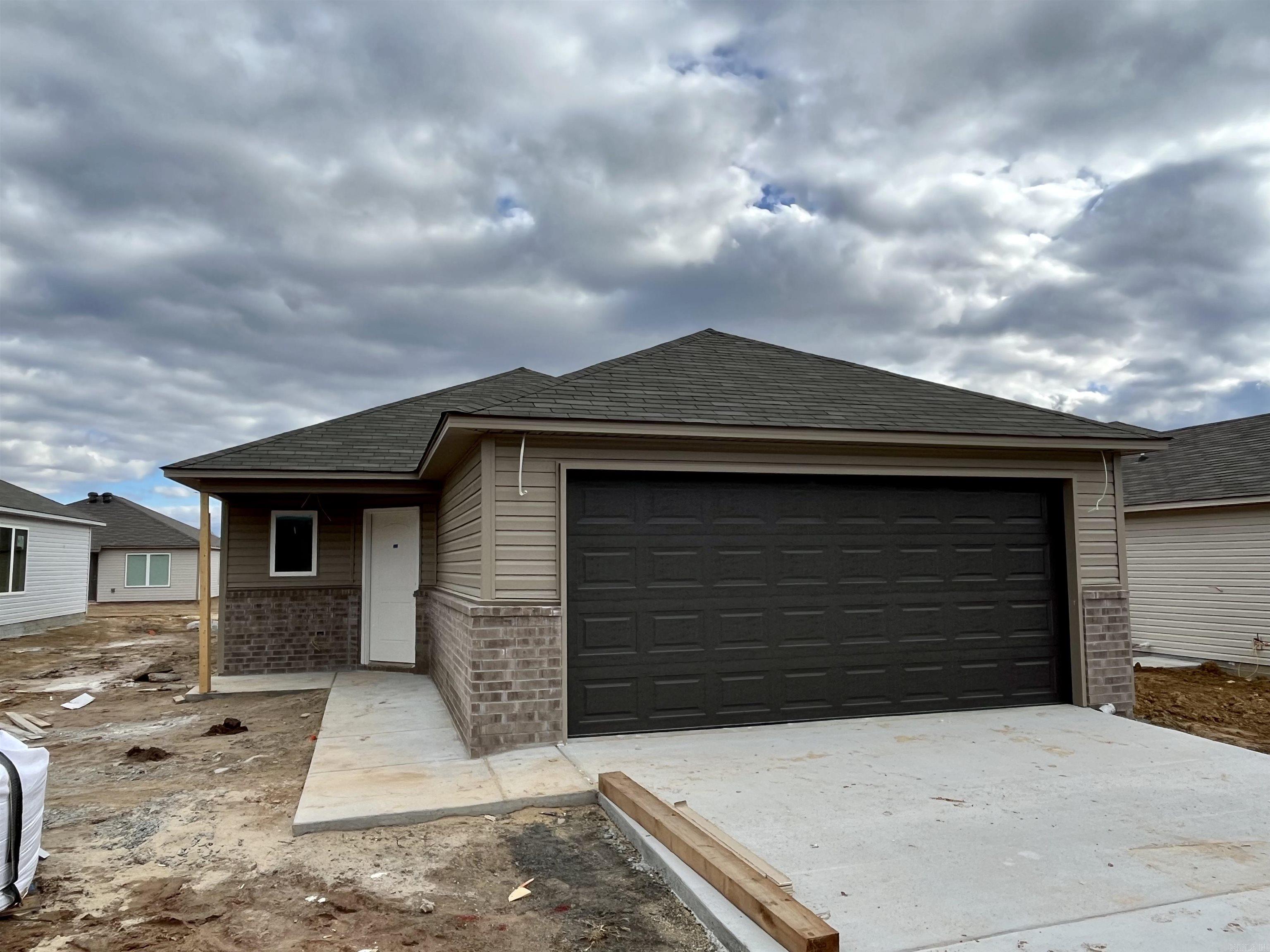 Come discover the Ridgeland plan. A clever offset door creates a modern look and saves space. Bedrooms 2, 3 & 4 are toward the front of the house, and the Master Bedroom is to the rear.   Upgrades thoughtfully included in this home: 14x7 uncovered patio, 2030 tempered Low E window in Master Bath, plumbing faucet upgrade 2, 16" laminate bar top in Kitchen, Luxury Vinyl Plank flooring in wet areas and Living Room and adjacent hallways, raised ceilings in Living Areas per municipal requirements, Cheyenne style interior doors, baseboards level 2, 25in wide attic stairs, LED disk lights in Living Room, full sod, microwave hood in Kitchen, smooth top range.   THIS HOME IS SCHEDULED TO BE COMPLETE IN MID JANUARY.
